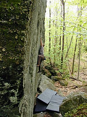 Tim Kemple bouldering the Black Jack Crack at Rumney, NH. Photograph by Joe McLoughlin.
