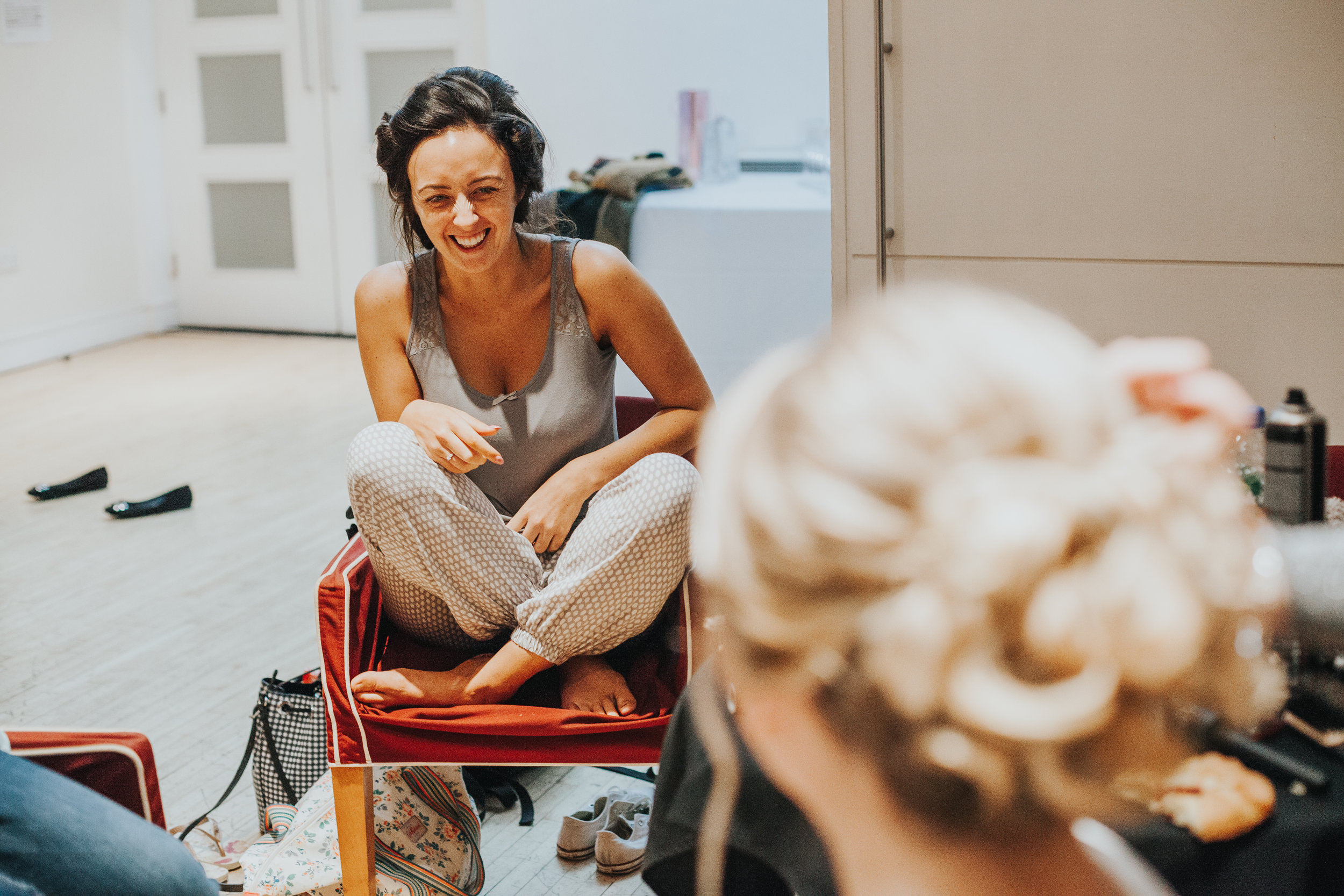 Bride laughing and getting ready