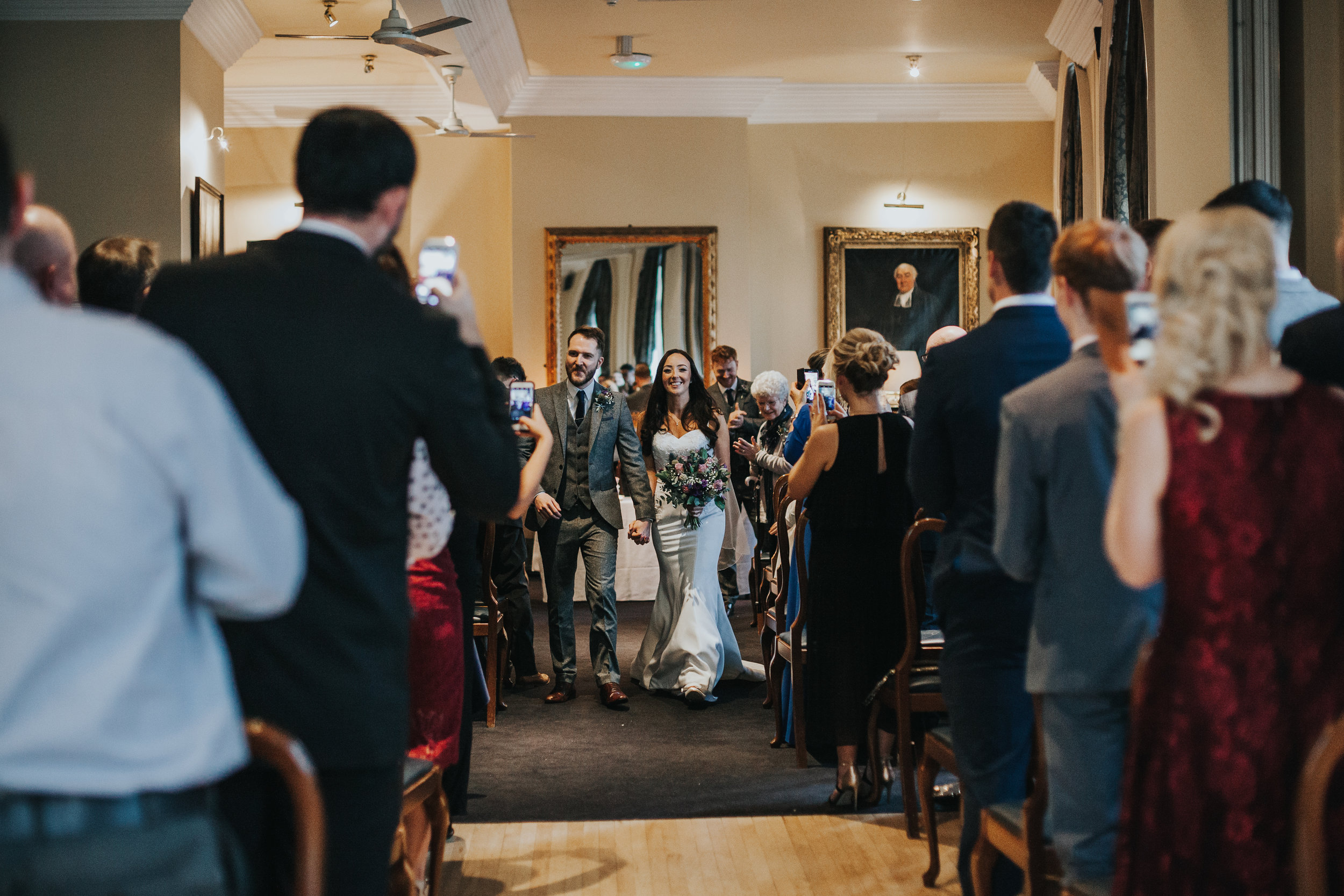 Bride and groom exit wedding