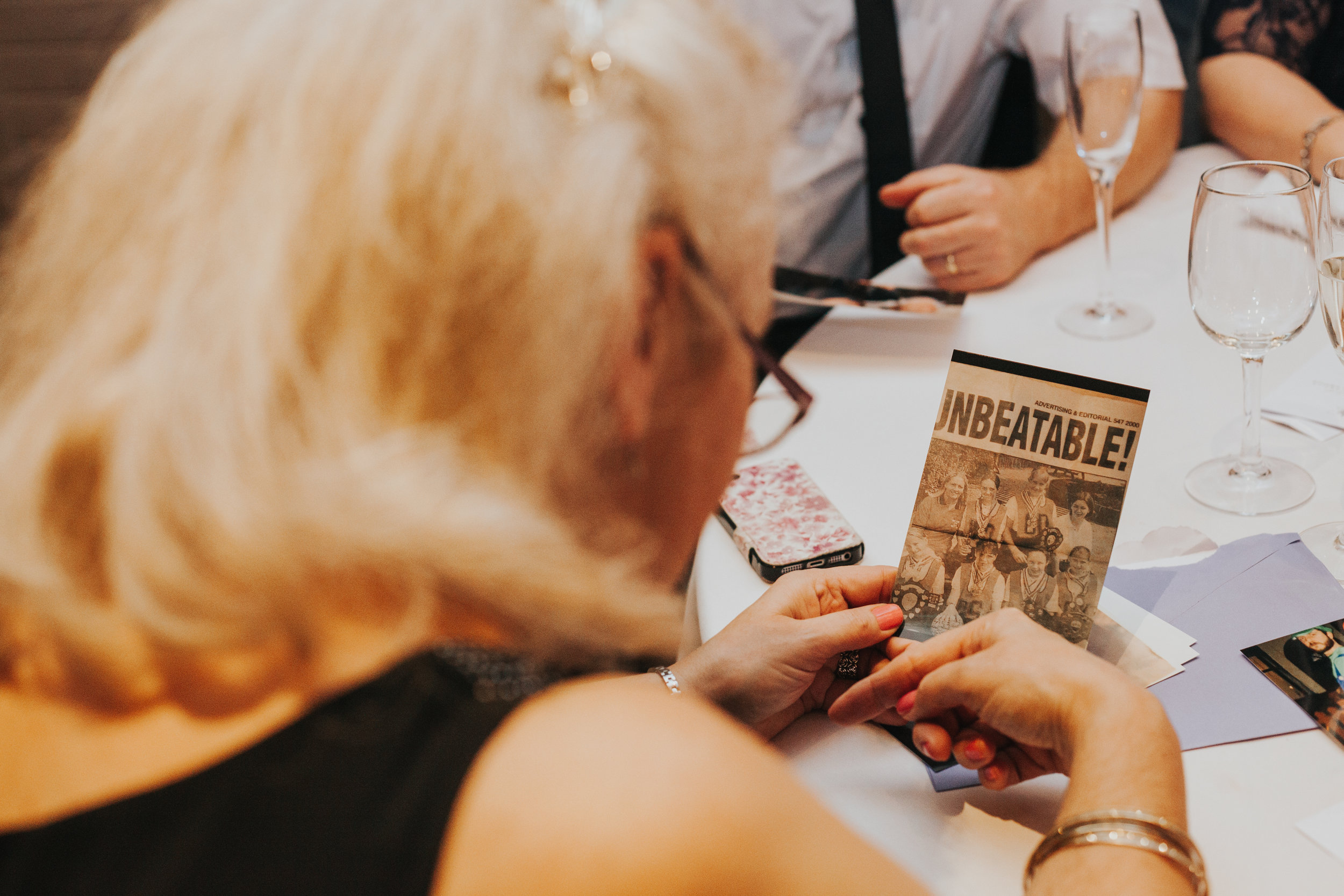 Guest looking at hand out from best woman