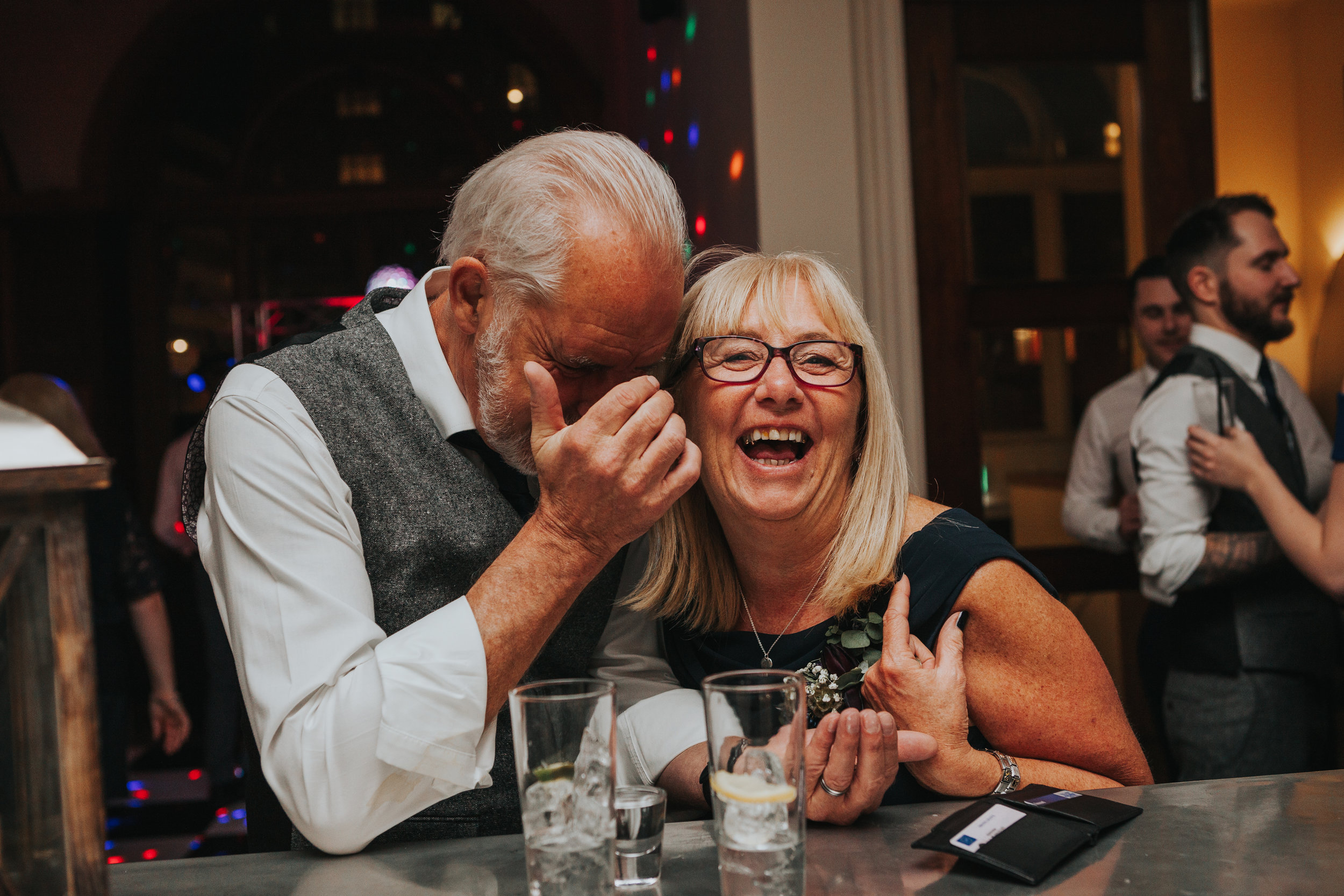 Couple laughing at bar