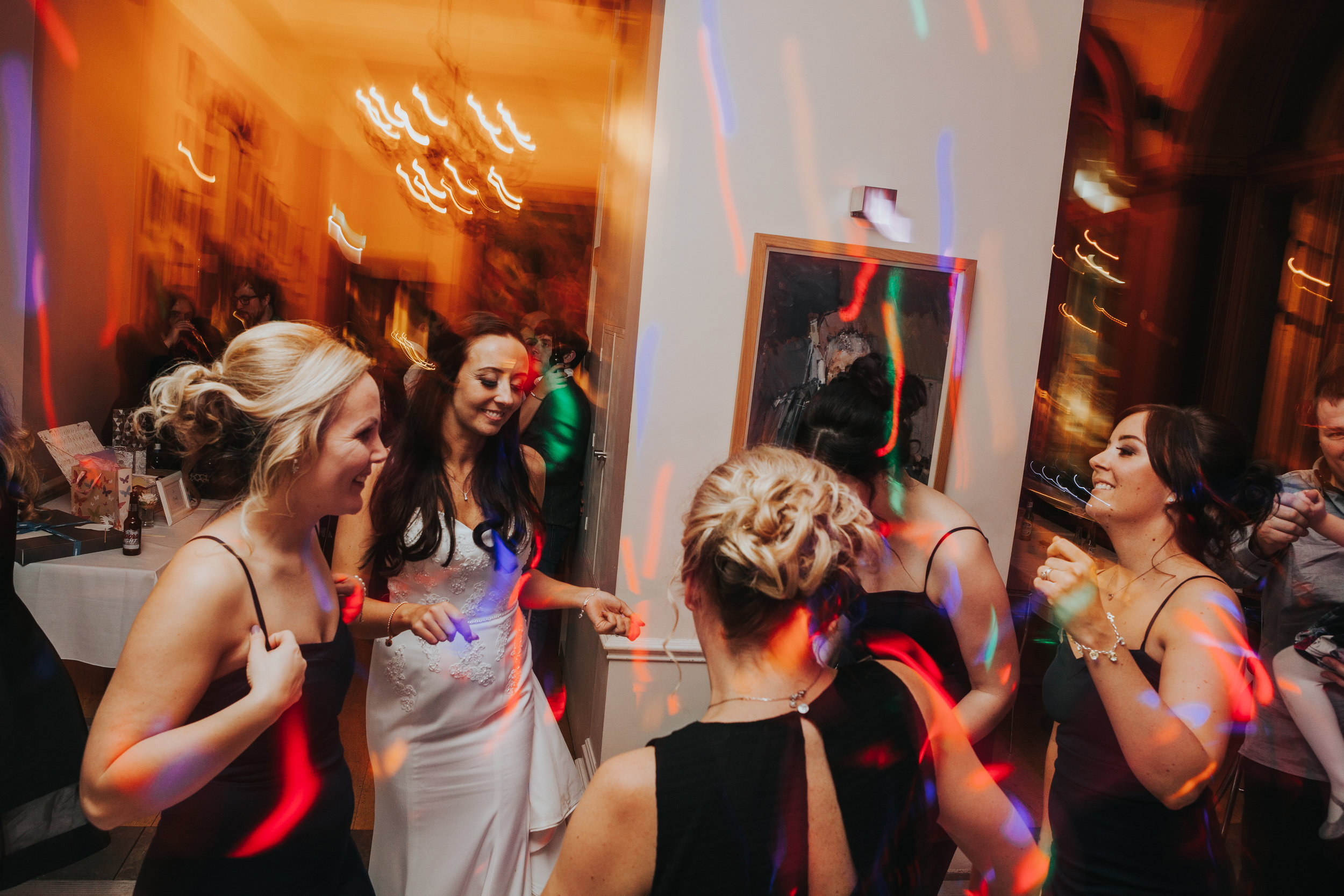Bridesmaids dancing together at The Racquet Club