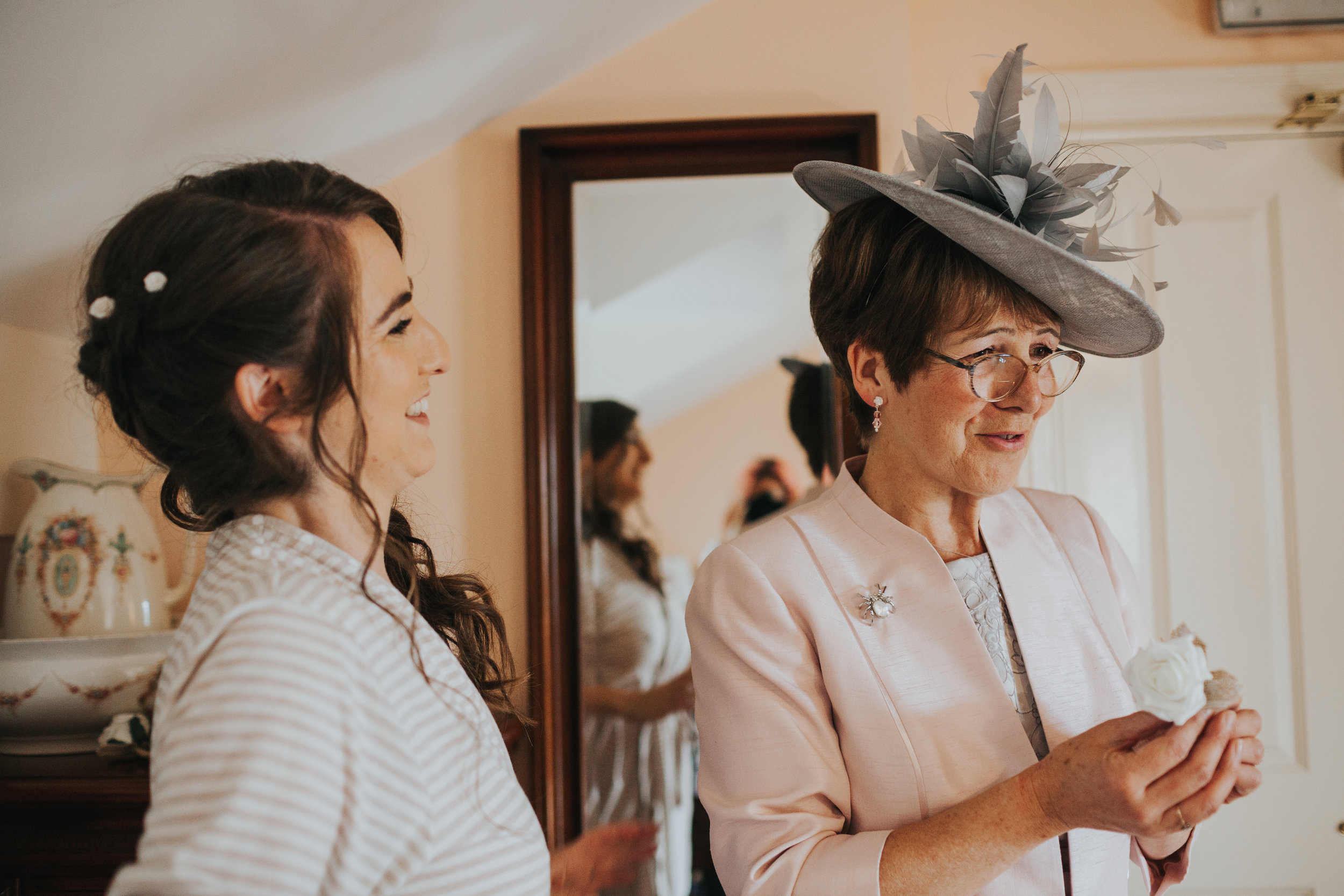  Bride laughs at Mum. Mum wears nice hat.&nbsp; 