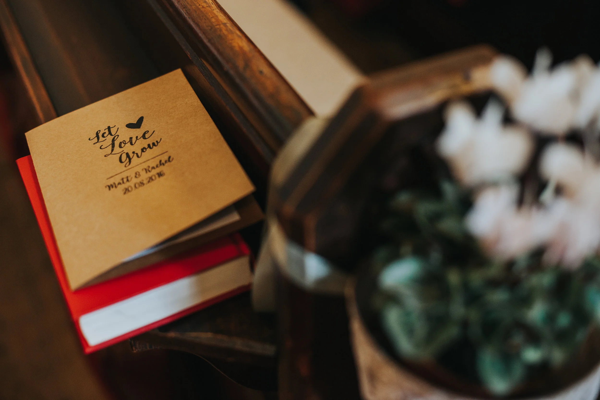  Let love grow service book accompanied by a pot of flowers. 