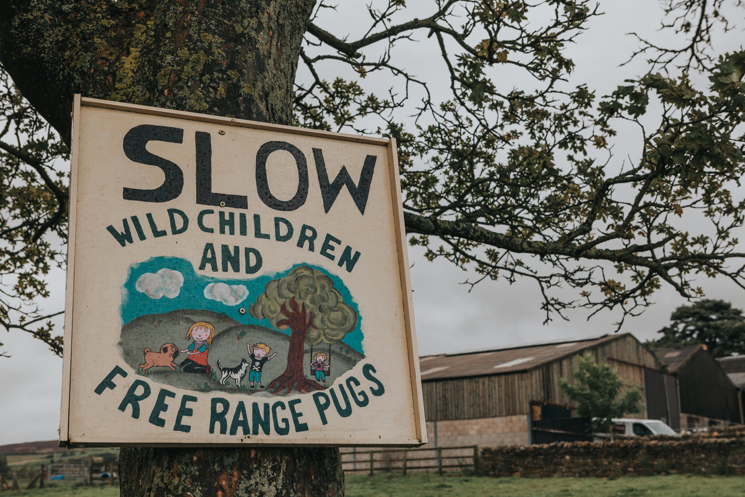  Sign reads "SLOW WILD CHILDREN AND FREE RANGE PUGS" We have arrived at Thornsett Field Farm it seems.&nbsp; 