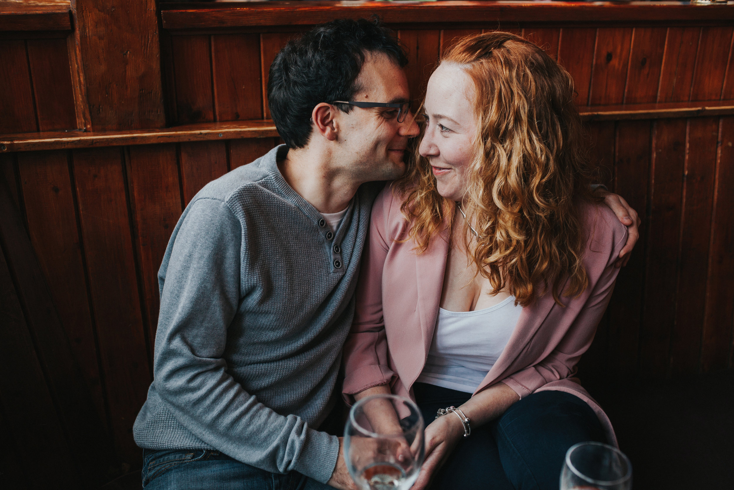 Couple inside bar, dark wood decor