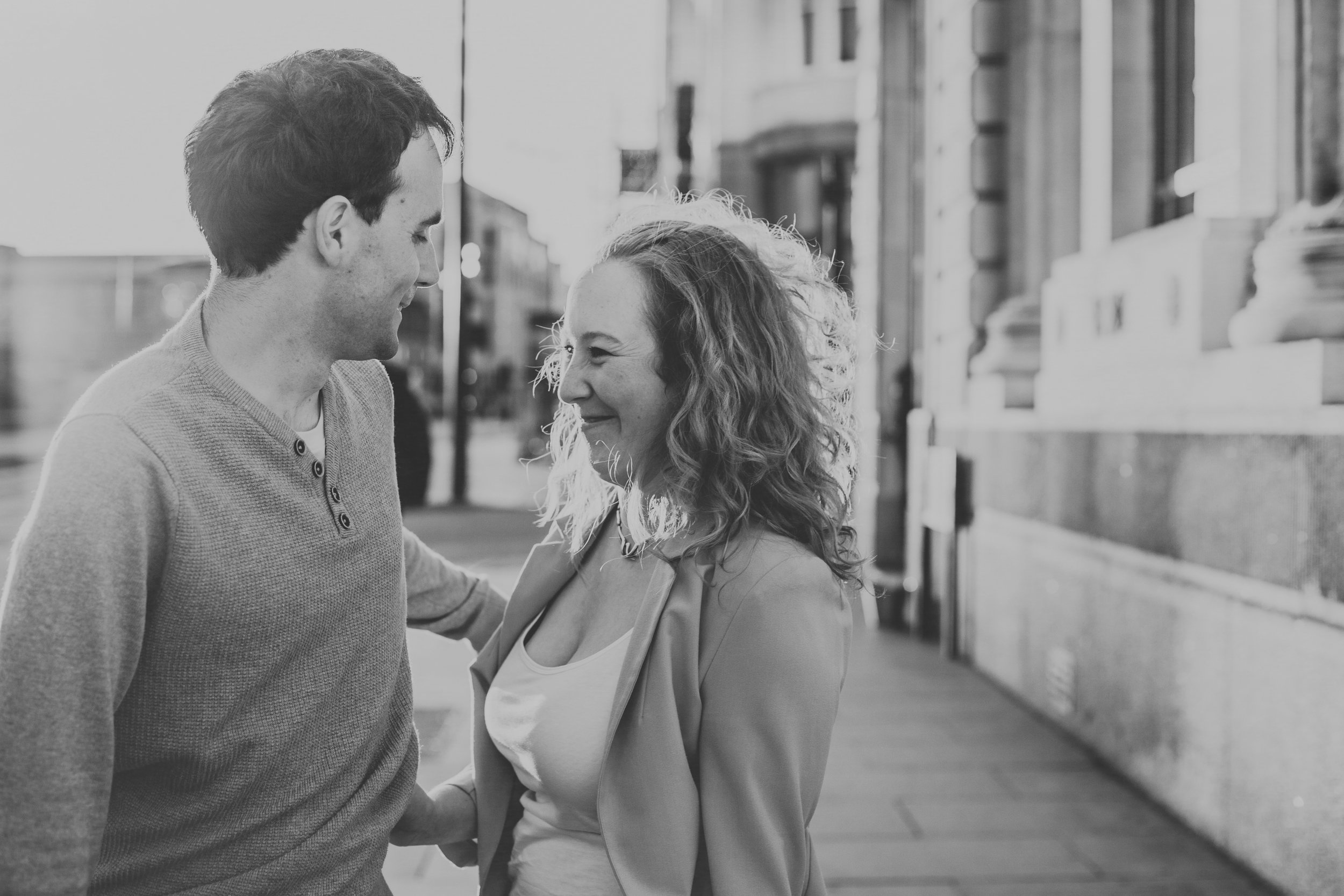 Jess and James in city street in black and white.