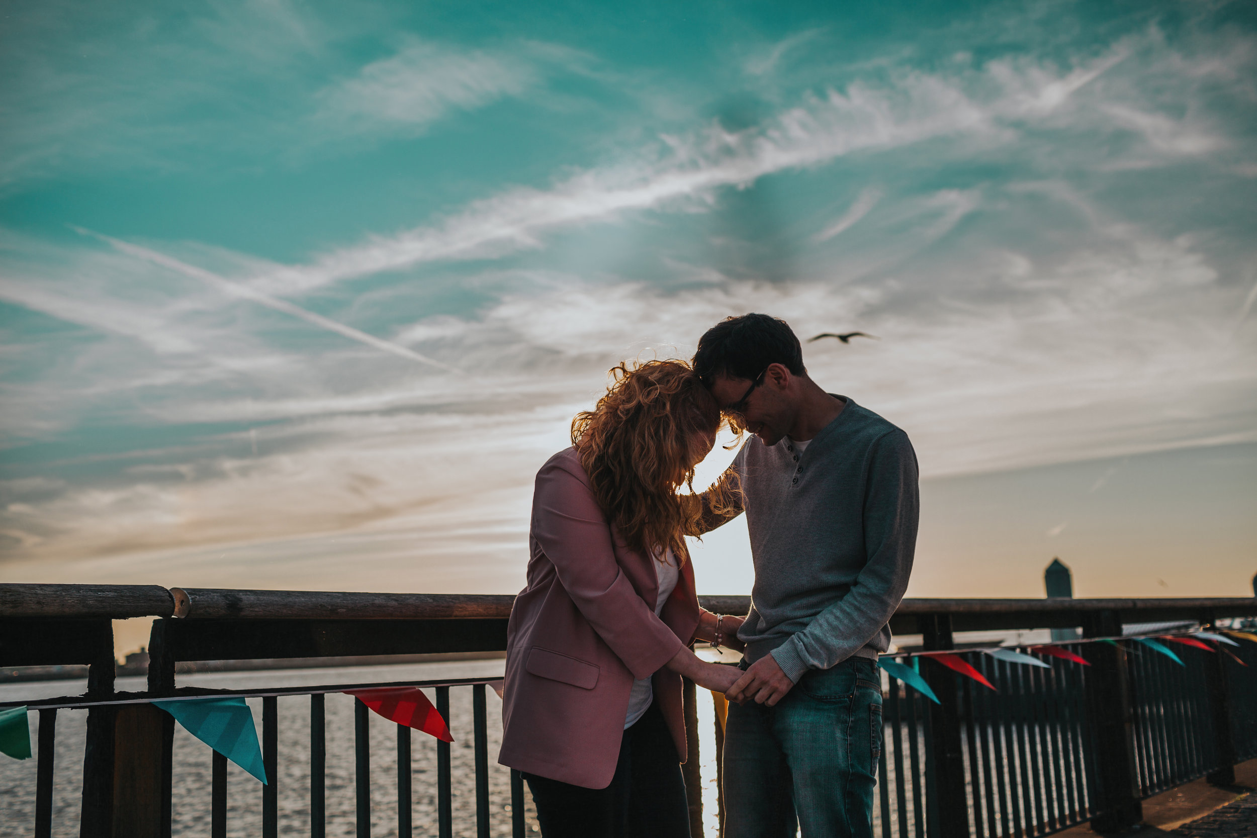 Couple in front of blue sky at Liverpool docks