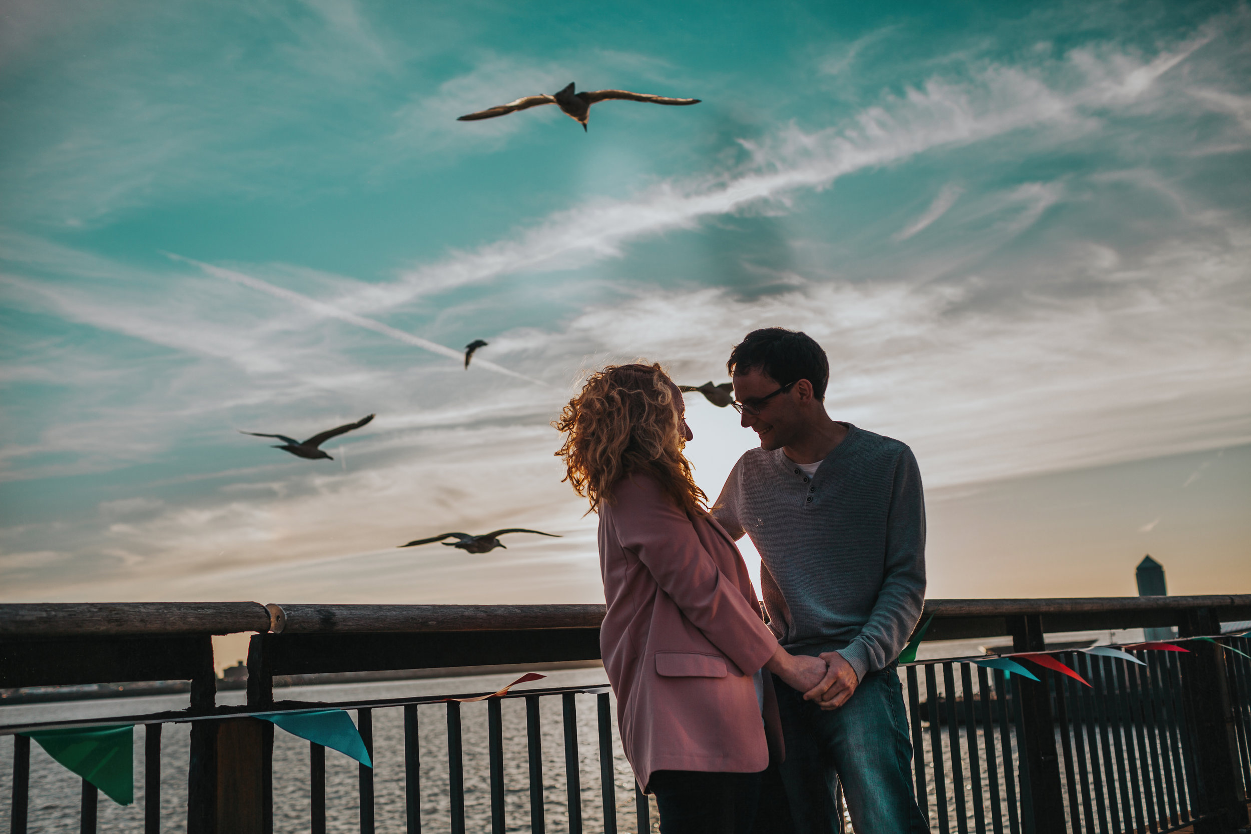 Couple with Seagulls and blue sky.