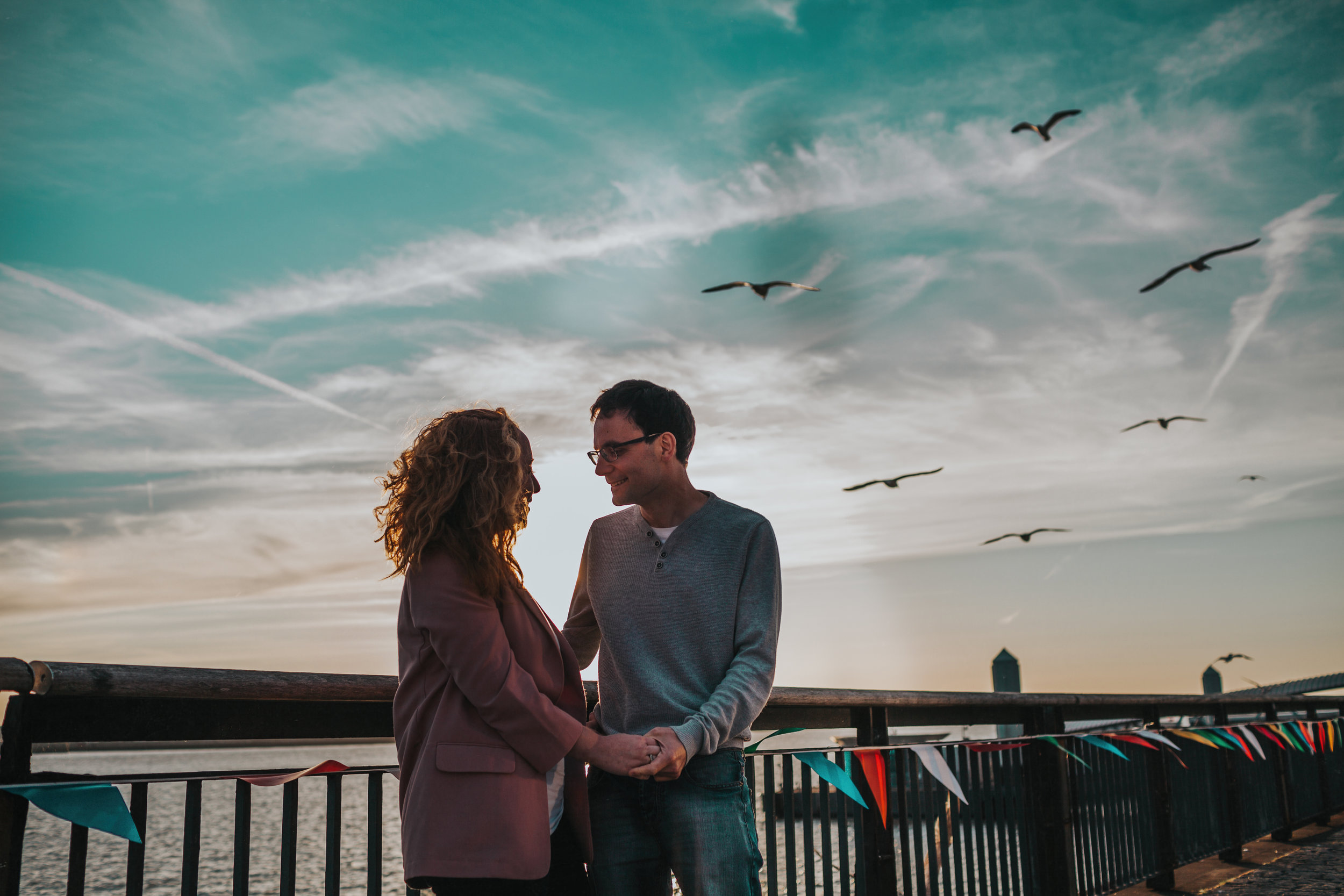 Couple and lots of birds behind them.