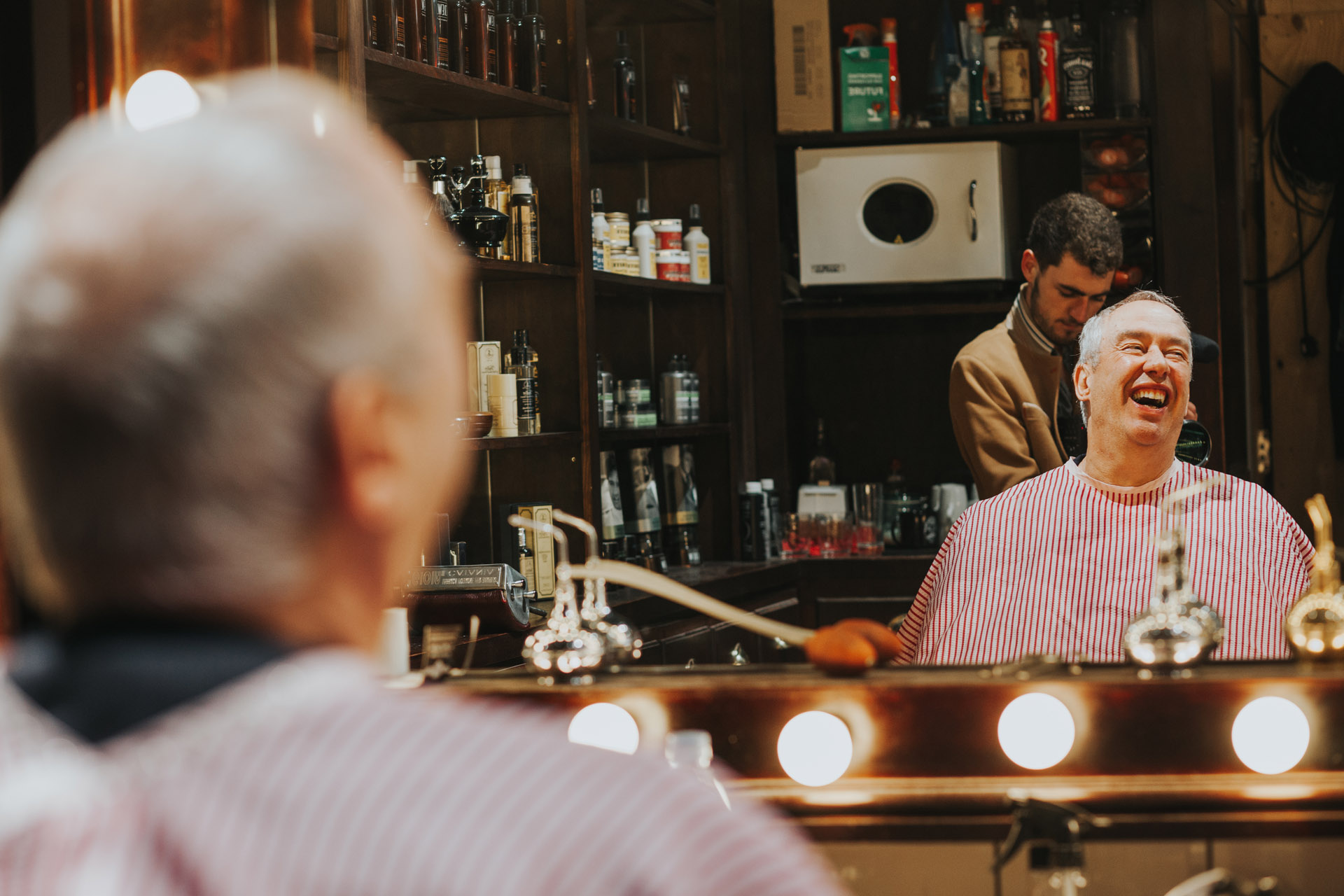 Groomsman laughing in the mirror