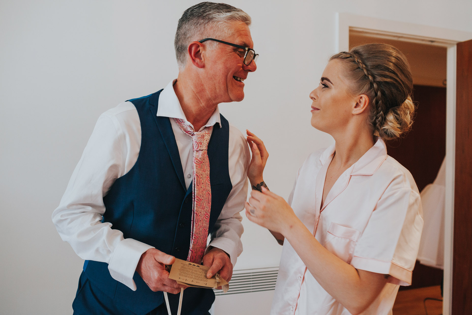 Bride and her father share a moment and she gives him a wedding morning gift.