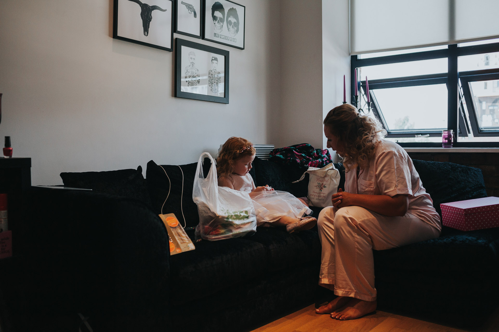 Bridesmaid and flower girl open their morning presents from the bride