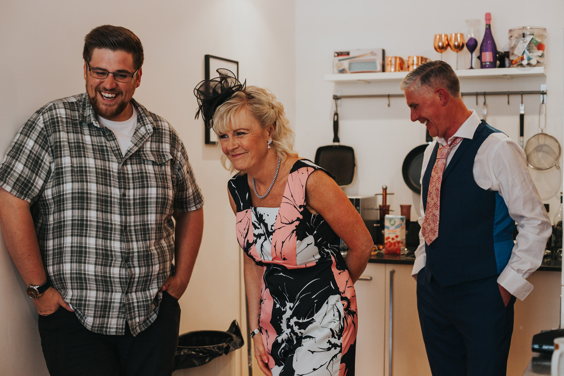 Brides parents and videographer share a wedding morning giggle. 