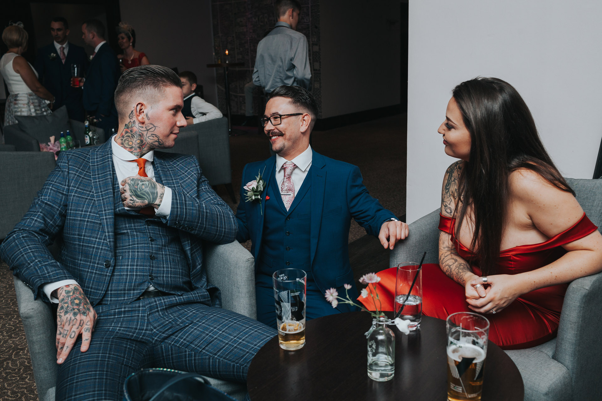 The groom laughs with friends.
