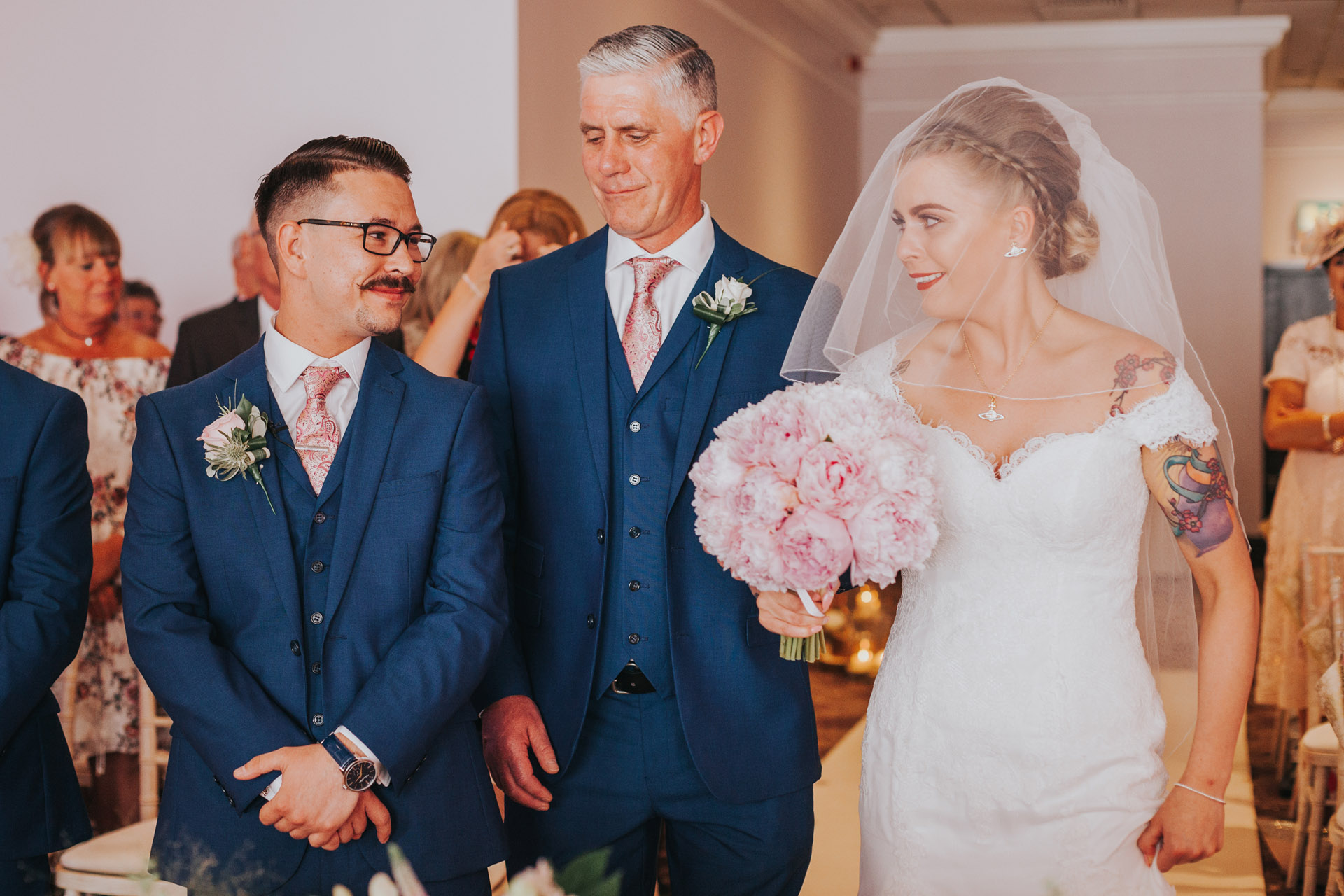 Groom looks at bride for the first time. 