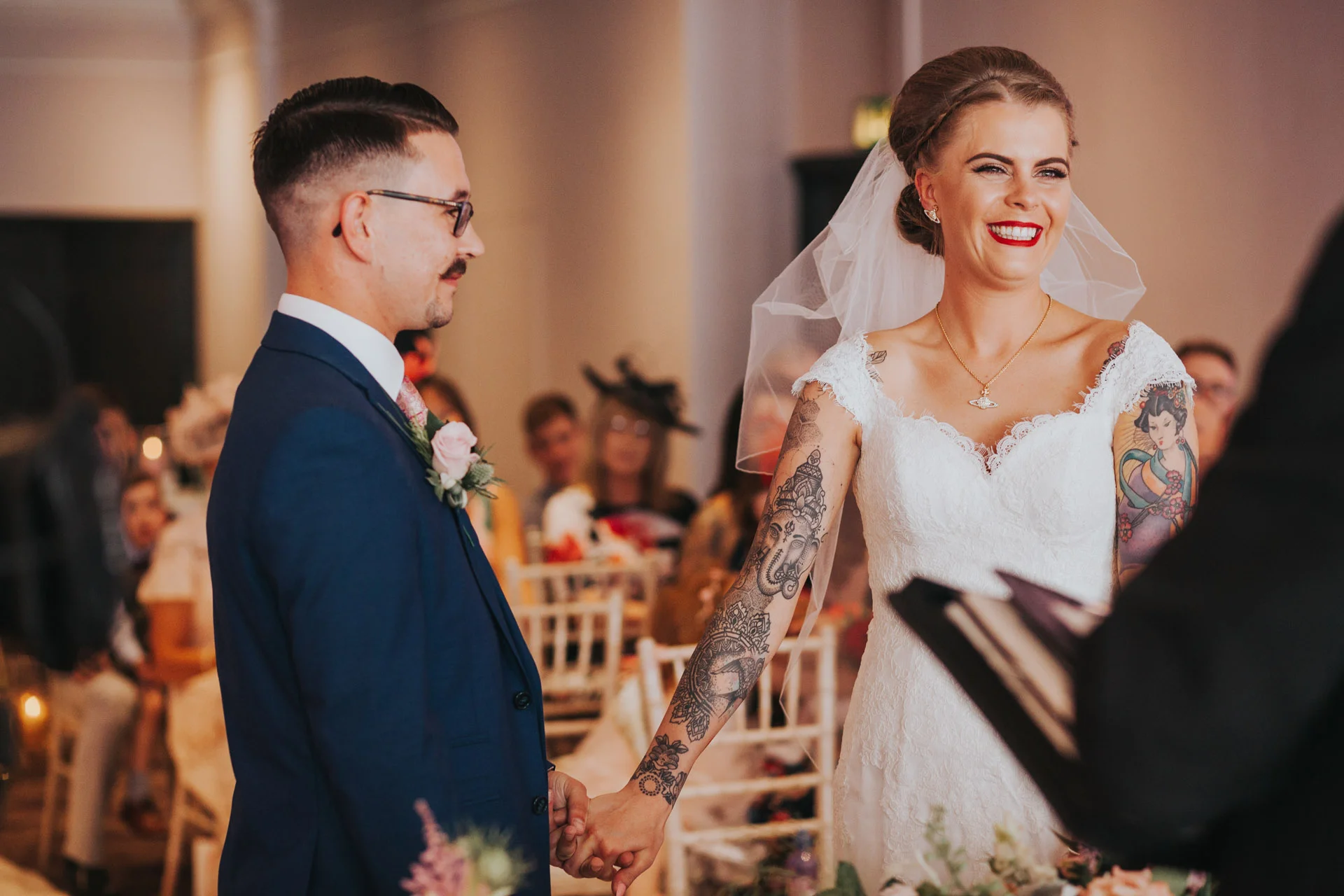 Bride looks at registrar excitedly. 