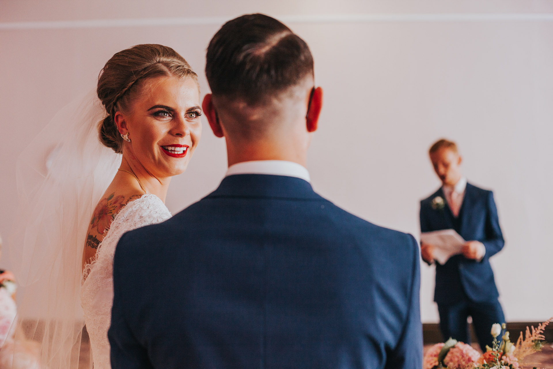 The Bride turns to the groom and laughs during the ceremony. 