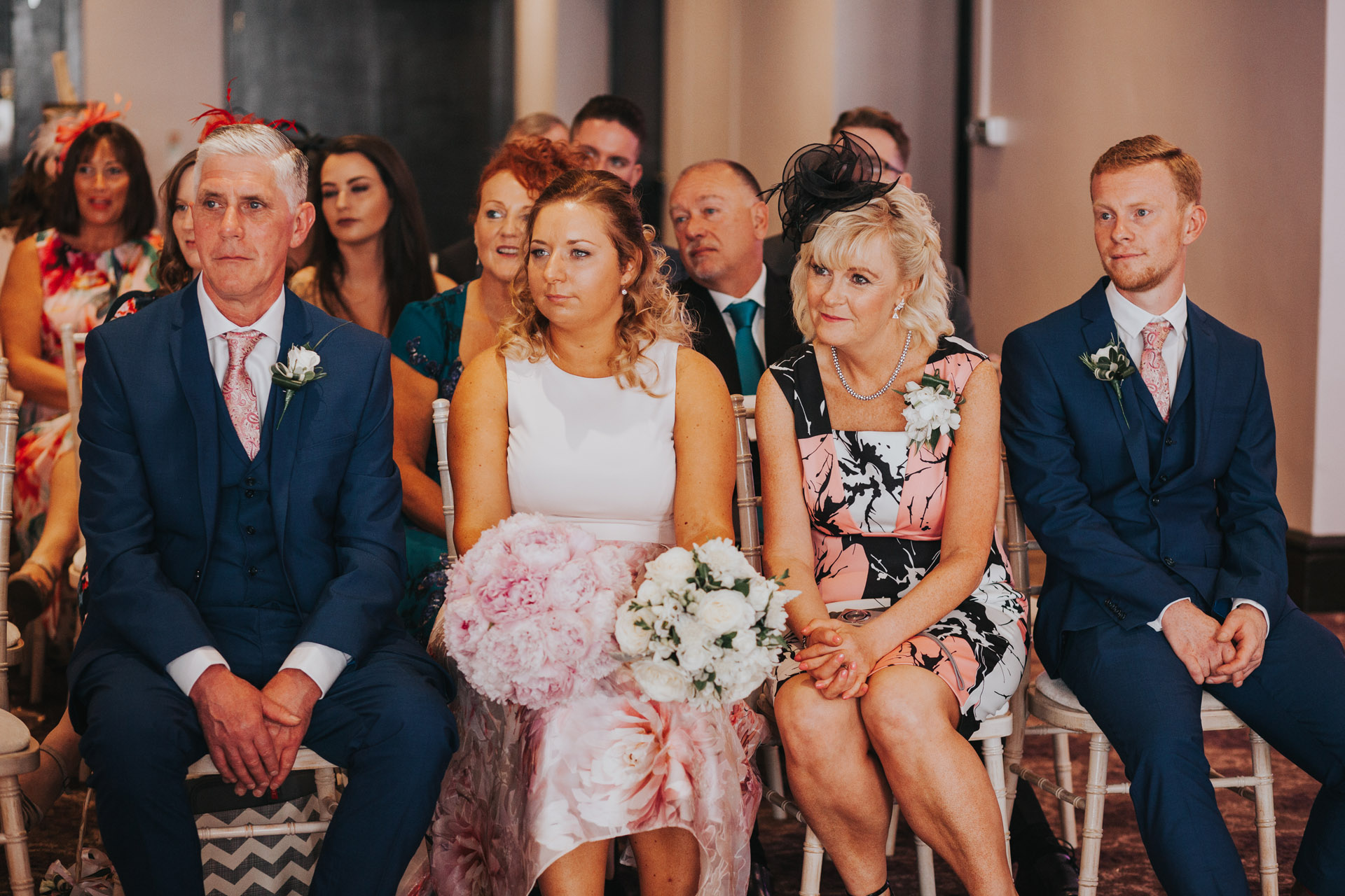 Brides family look emotional as they watch ceremony. 
