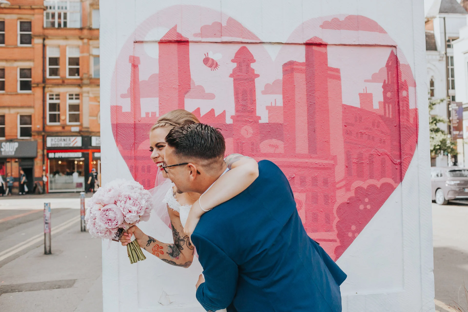 Bride and Groom have their photographs taken in Stevenson Square Manchester. 