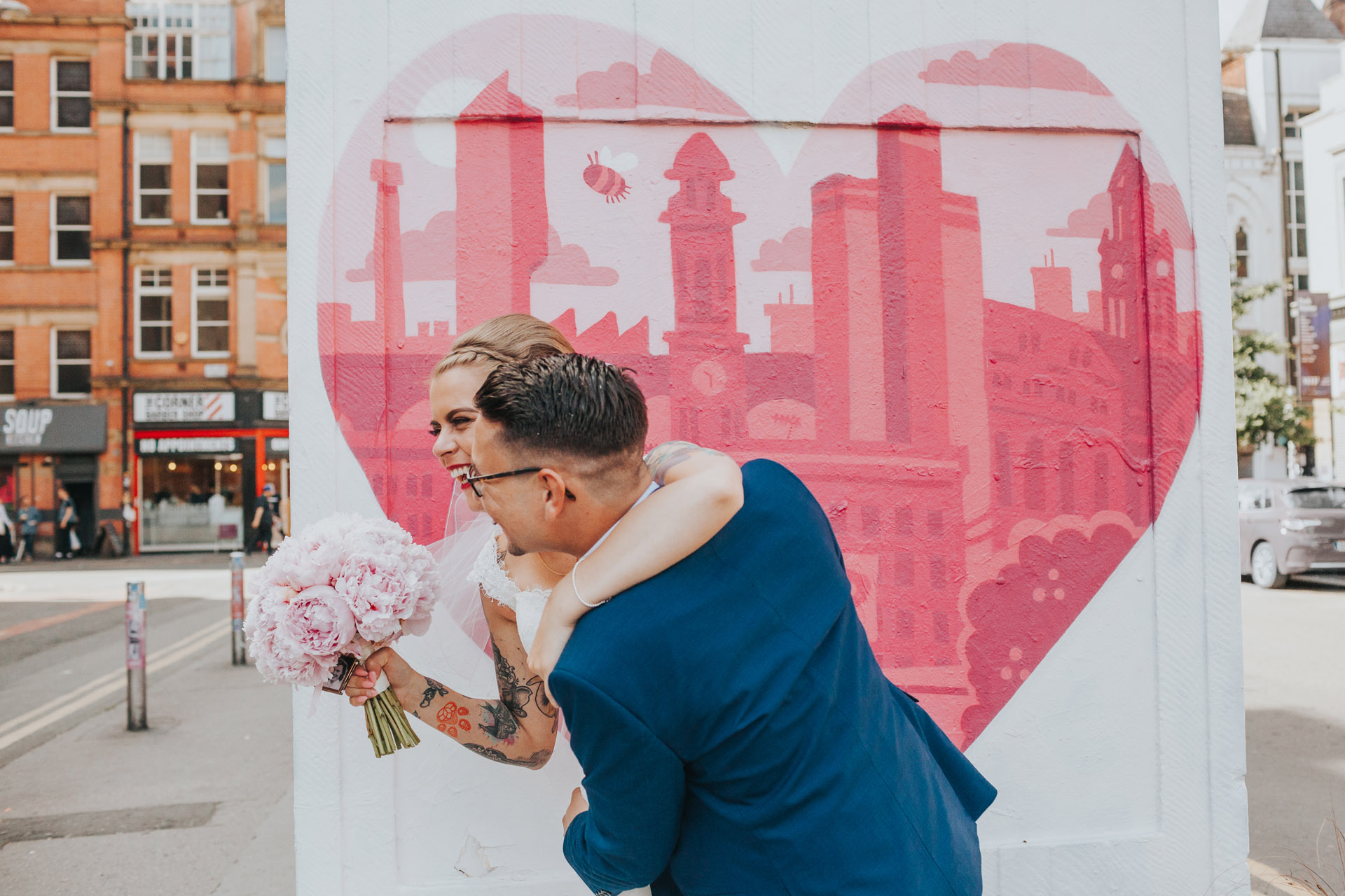 Bride and Groom have their photographs taken in Stevenson Square Manchester.