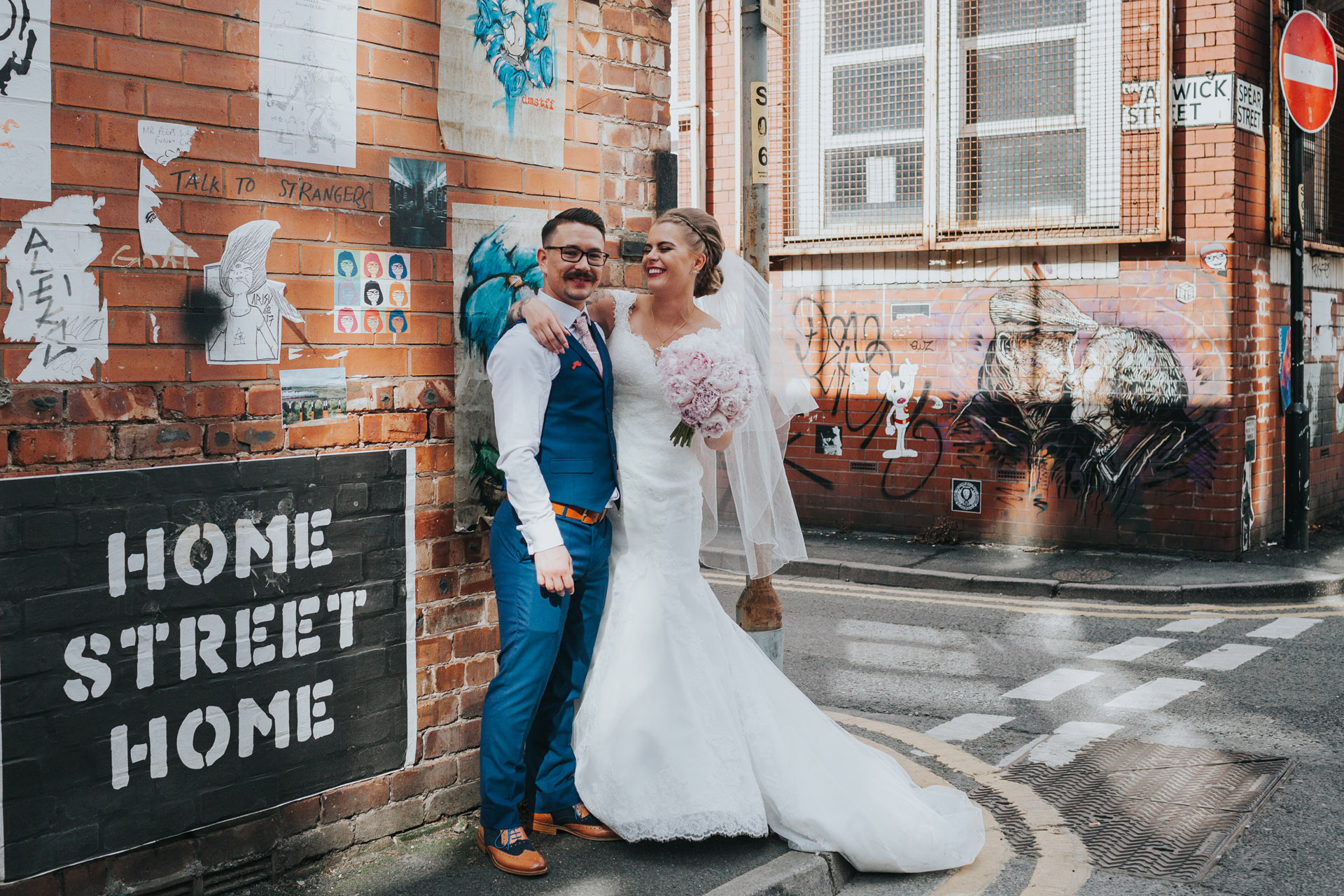 Bride and Groom stand on Warwick Street, Manchester for photograph.