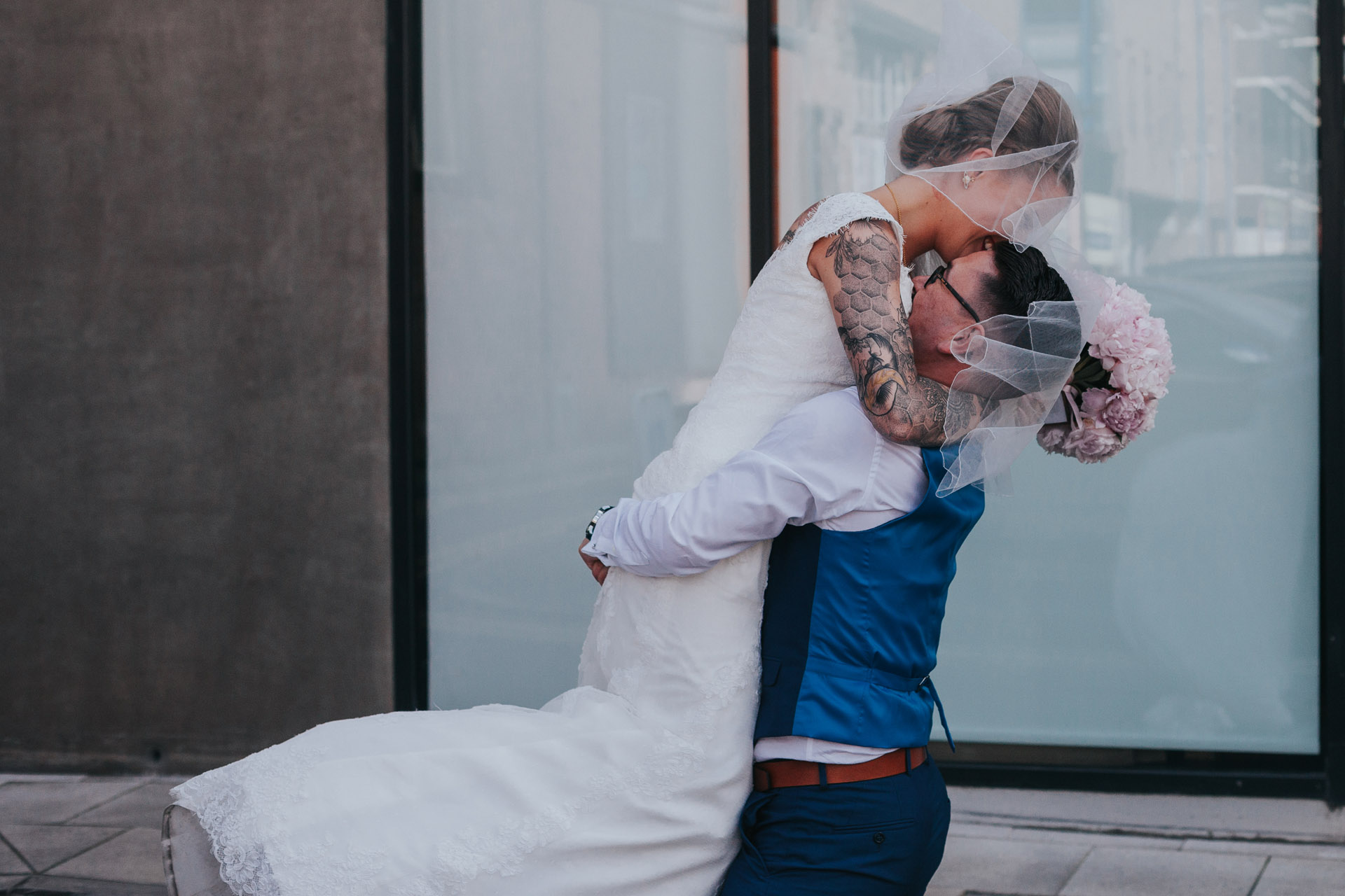 Groom lifts up bride.