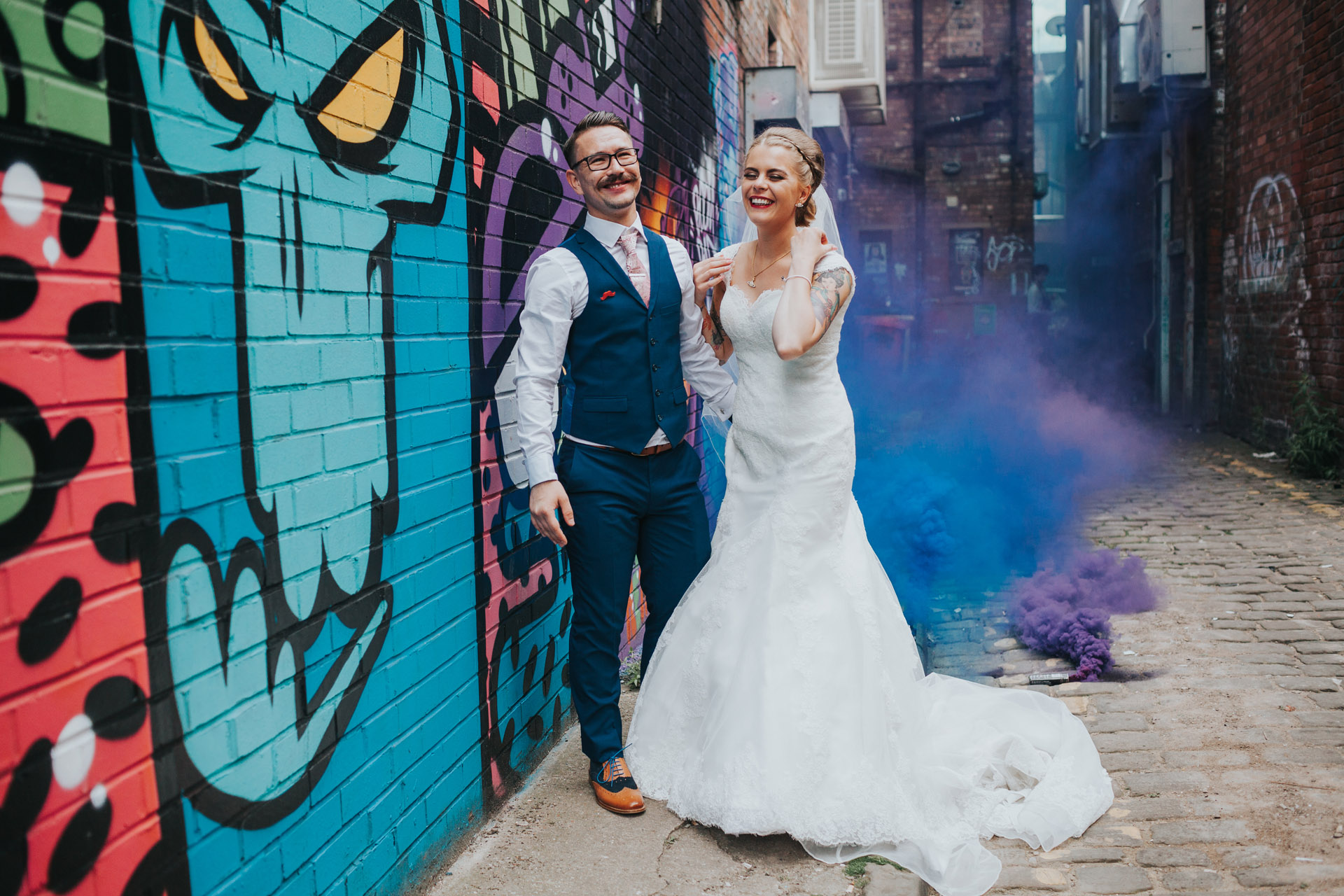 Bride and Groom in front of graffiti in Manchester. 