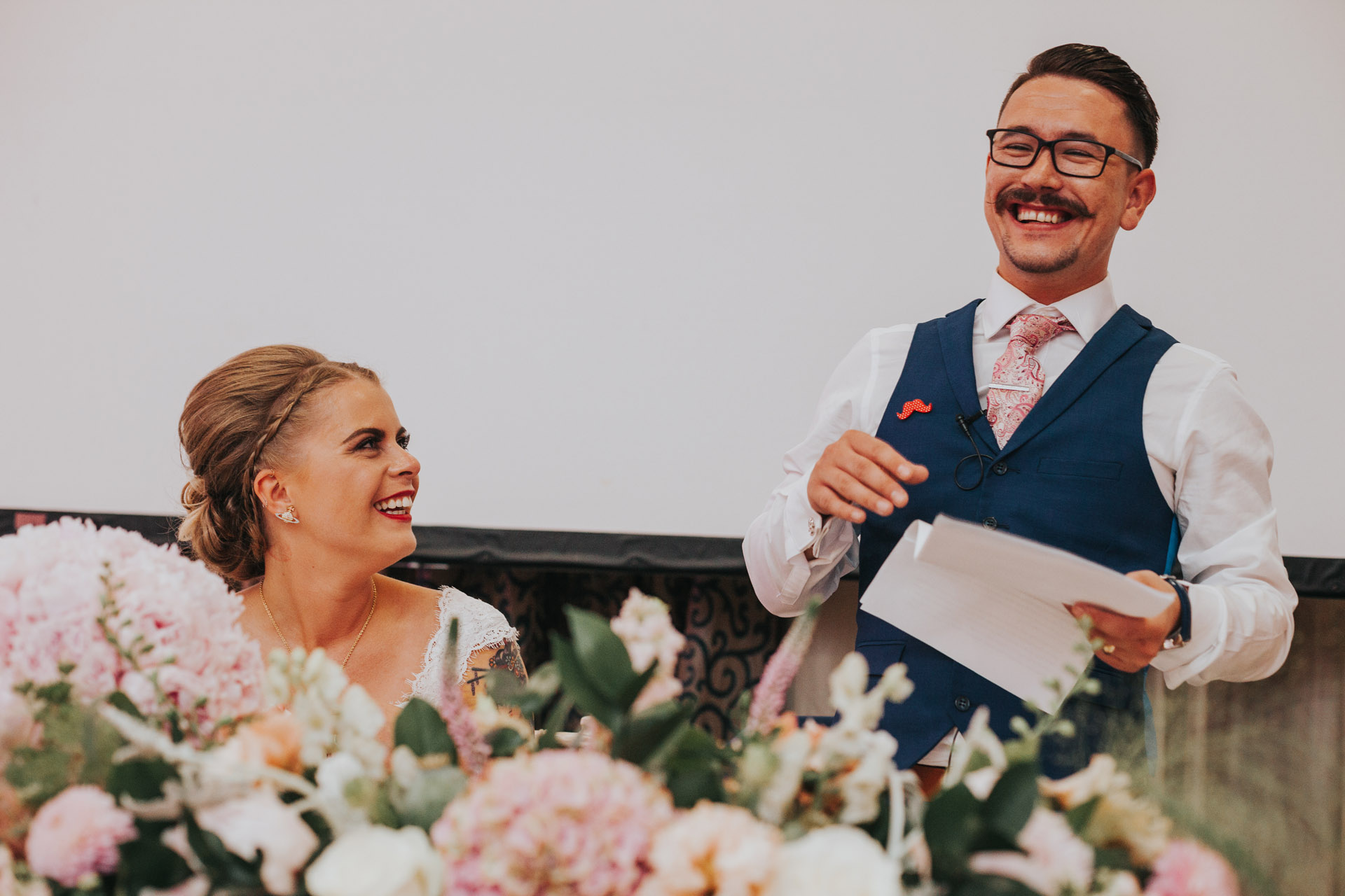 Bride listening to grooms speech.