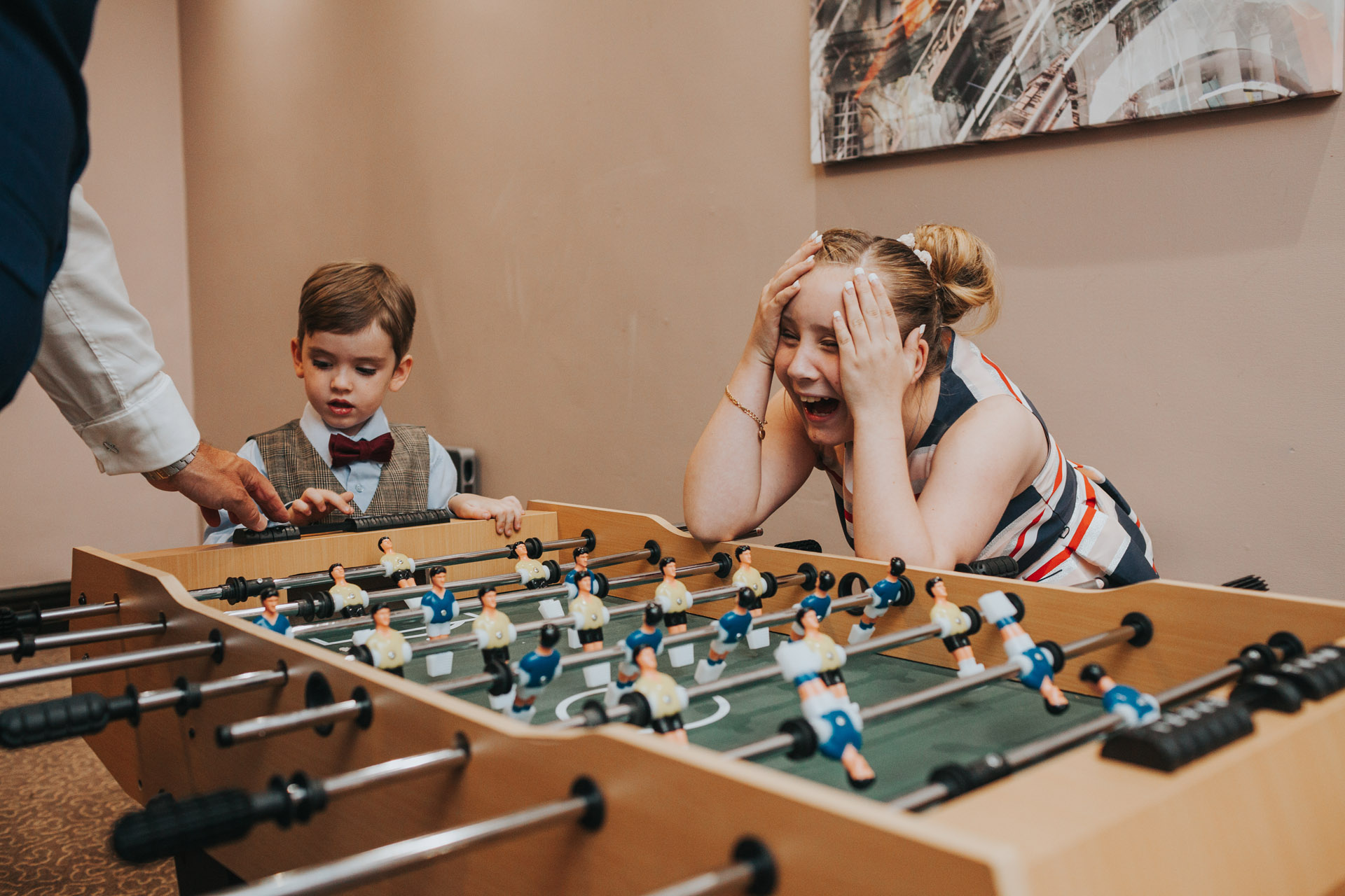 Children playing table football at wedding. 