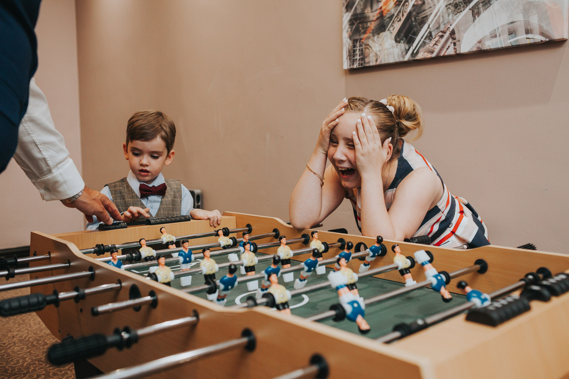 Children playing table football at wedding.