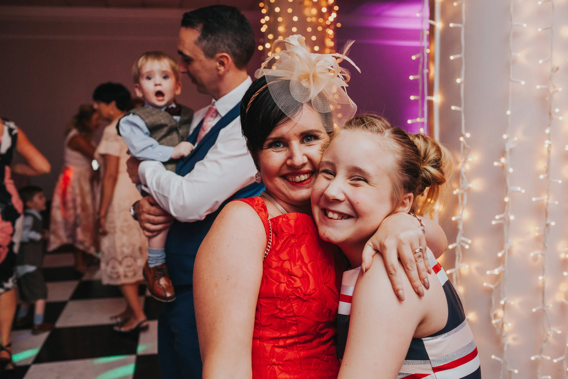 Wedding guests posing for photos on dance floor