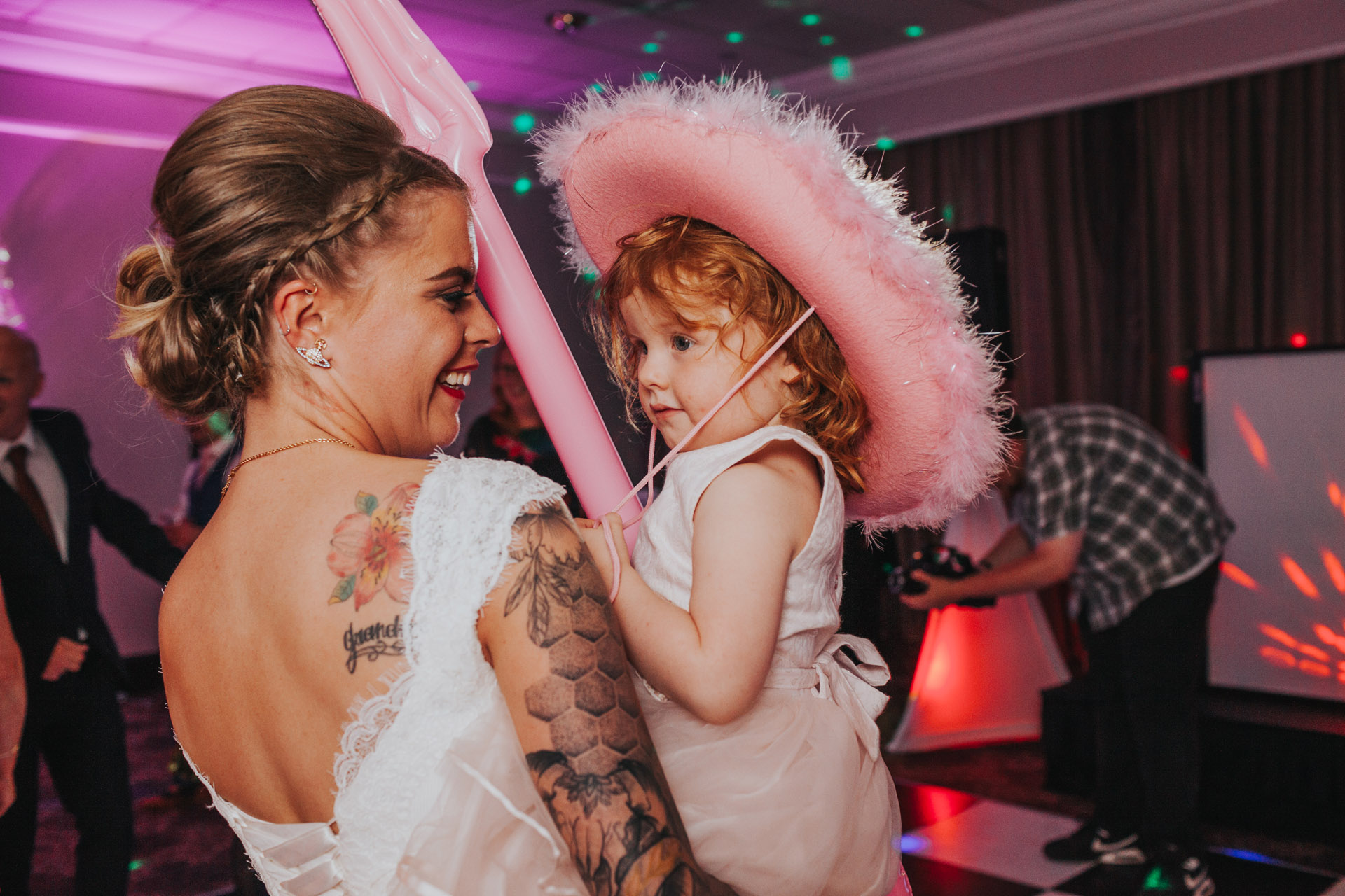 Bride dancing with flower girl. 