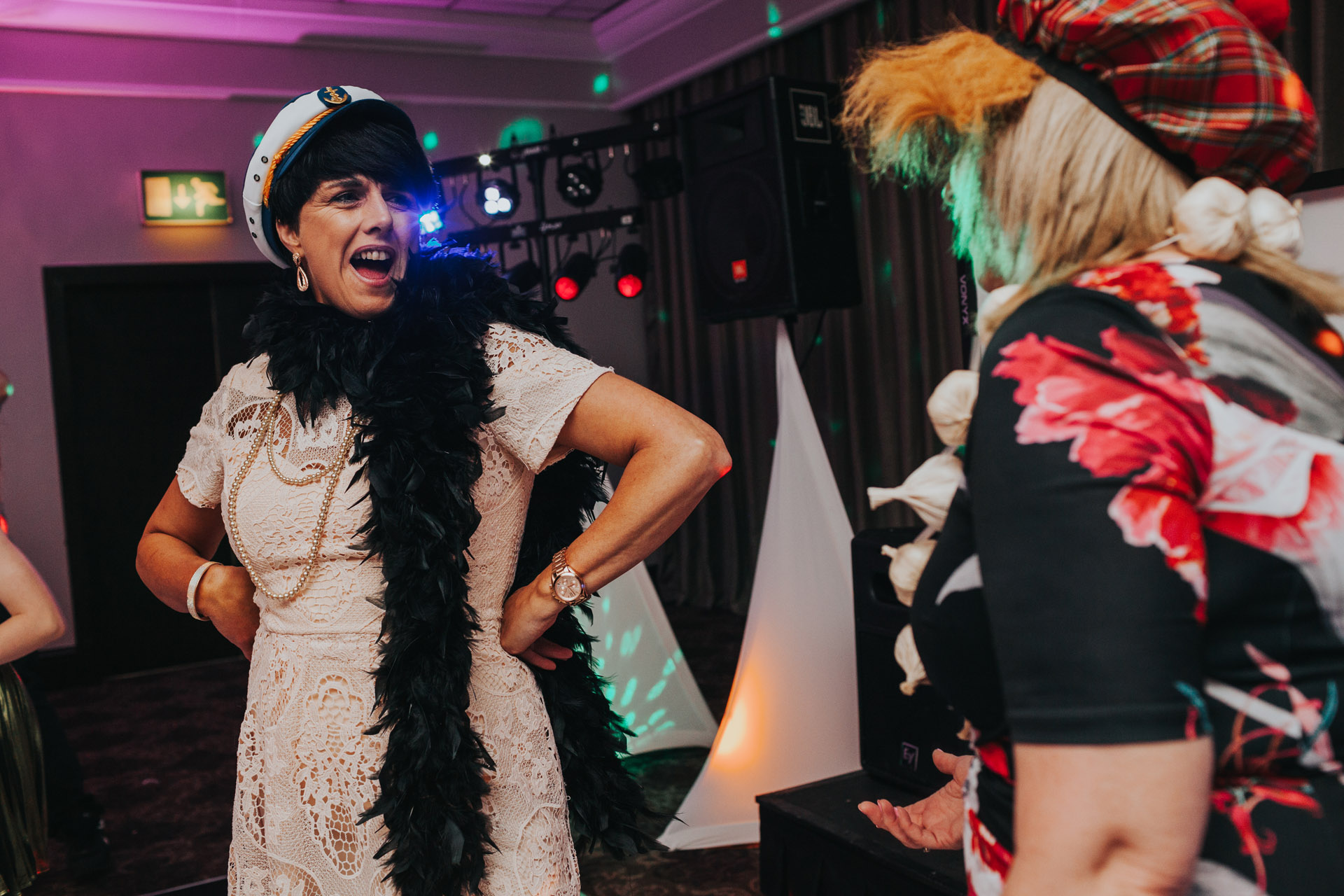 Lady wearing sailors hat at wedding party. 