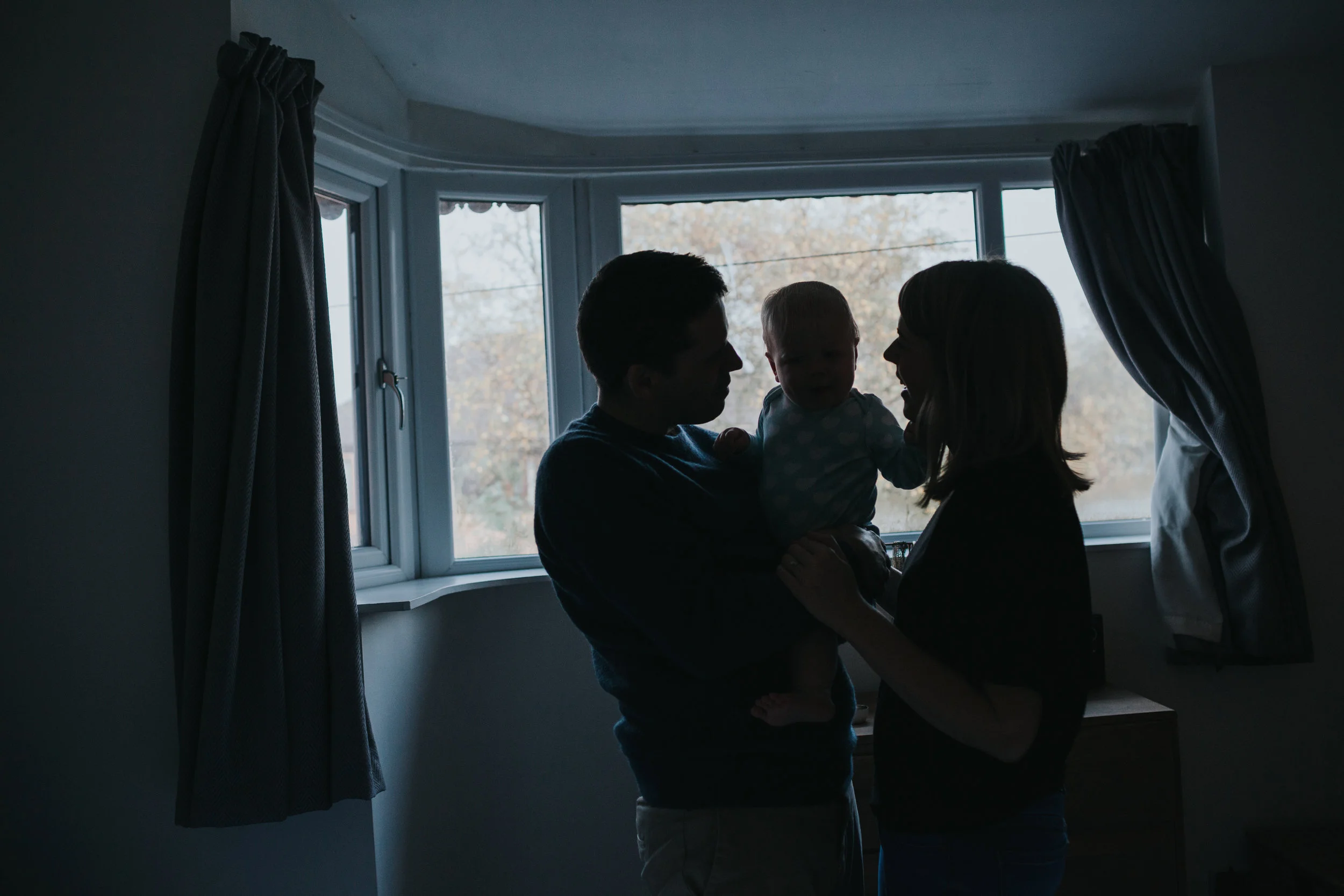 Family silhouette in bedroom window