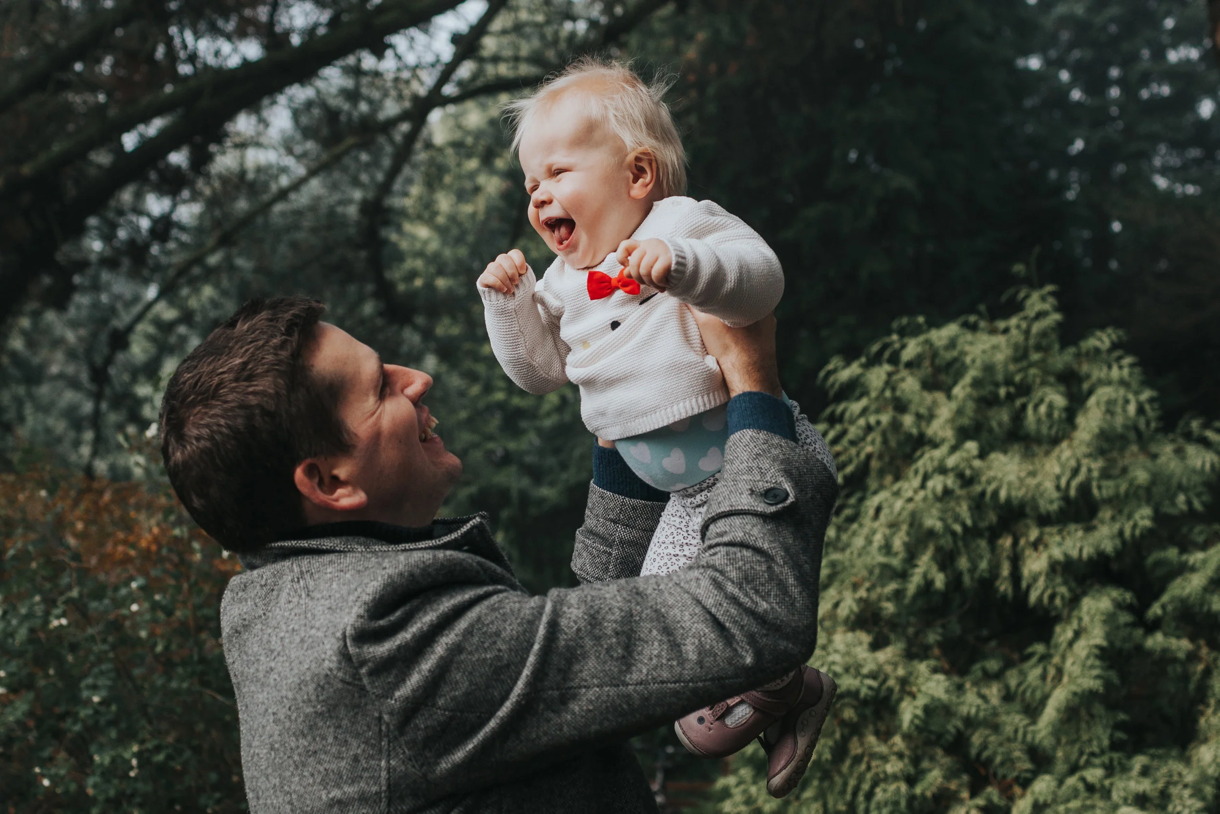 Dad throws Evie up in the air.