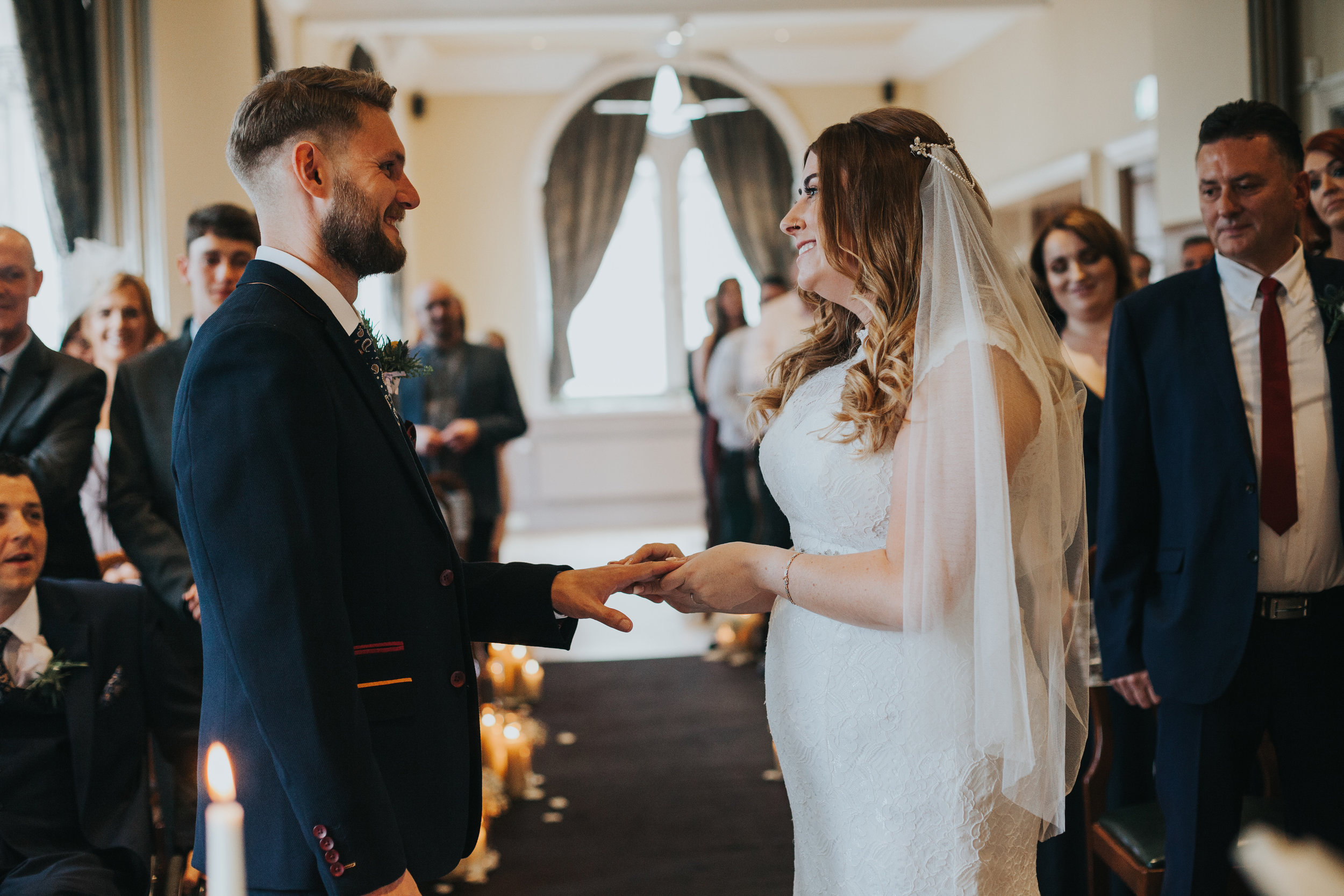 Bride and groom exchange wedding rings.