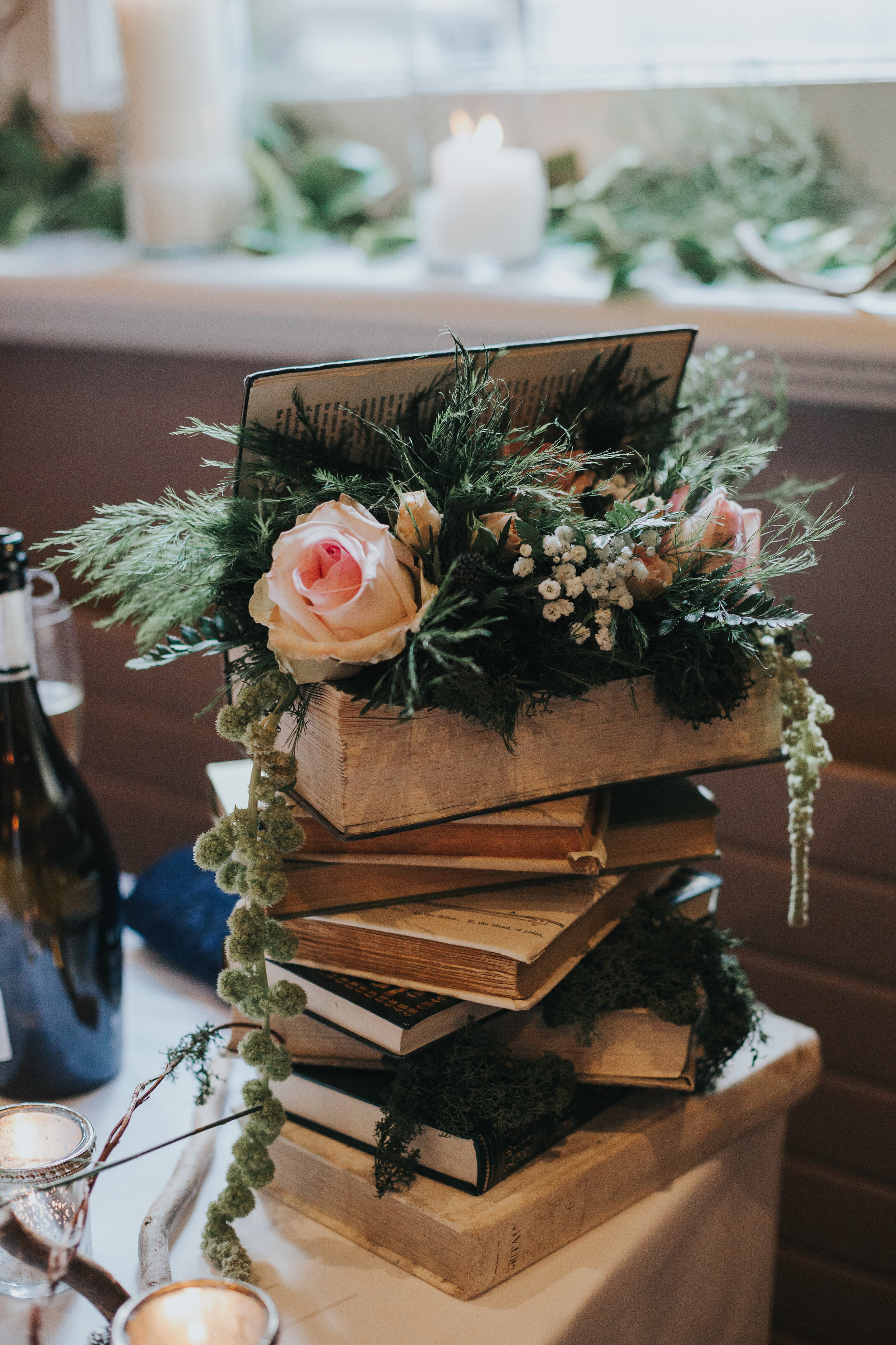 Books stacked with roses.