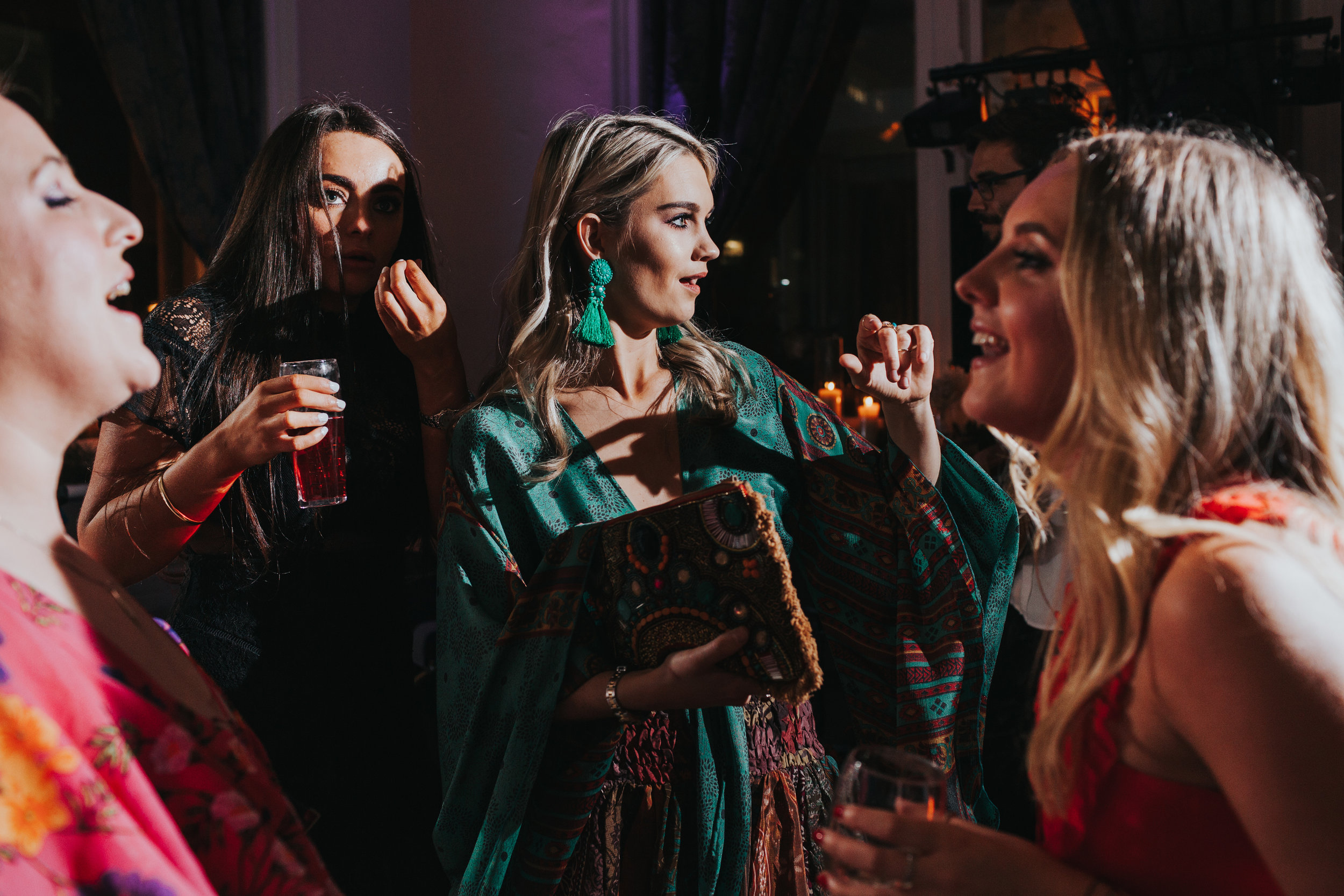 Wedding guest in green dress dancing.