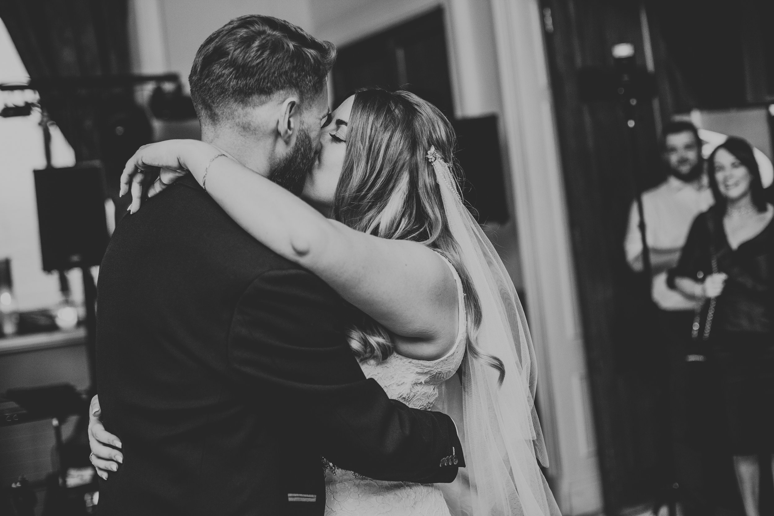 Bride and Groom kiss on dance floor. 