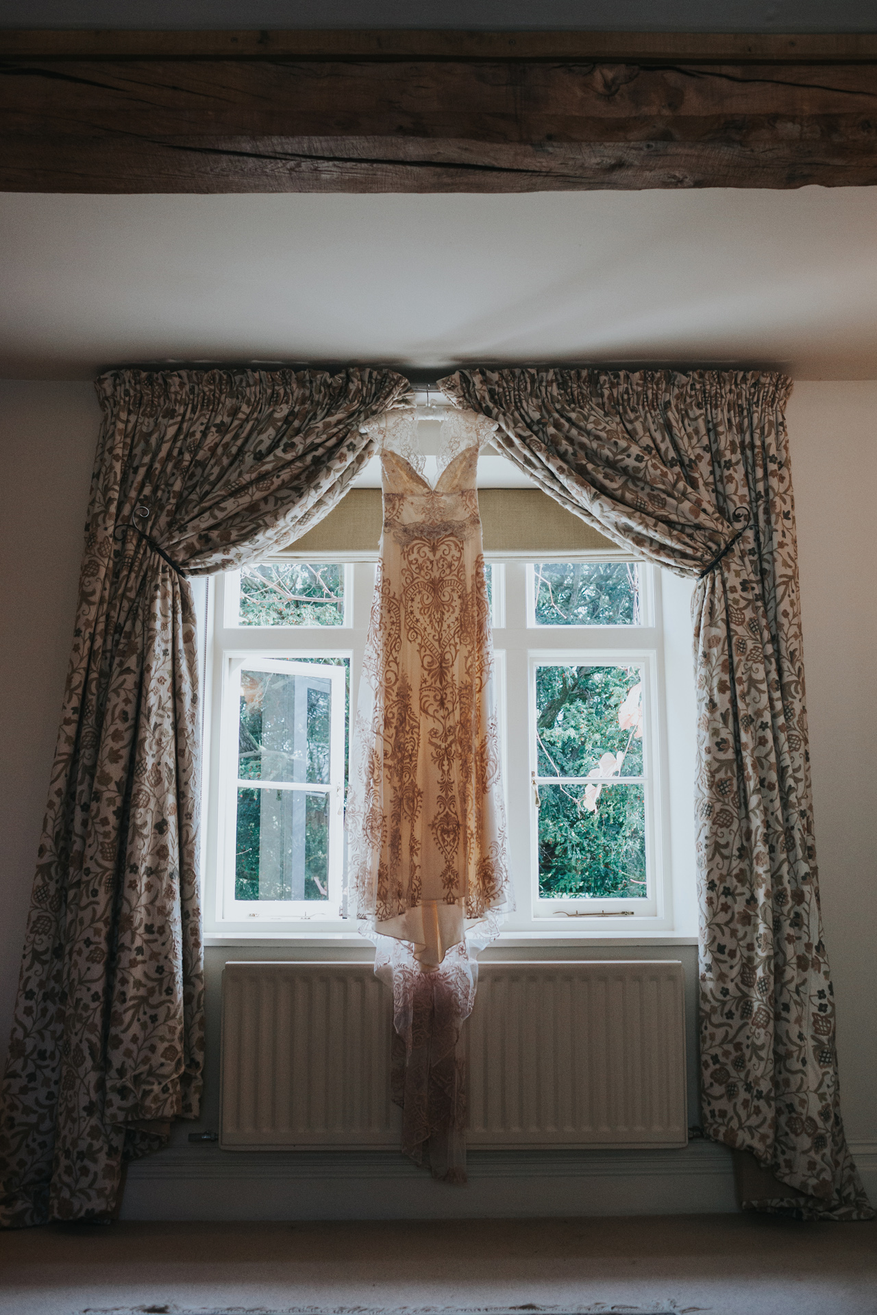 The dress hanging from the curtain rail at Dewsall Court.