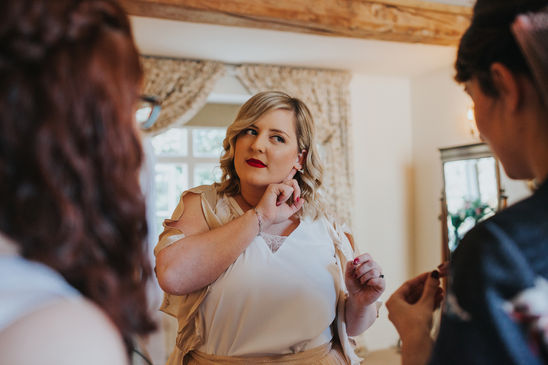 Bridesmaid shows off her ear ring.
