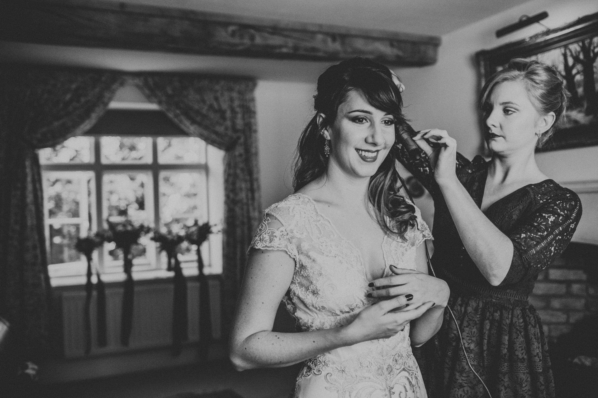 The bride looking excited about the day ahead. Photograph in black and white. 