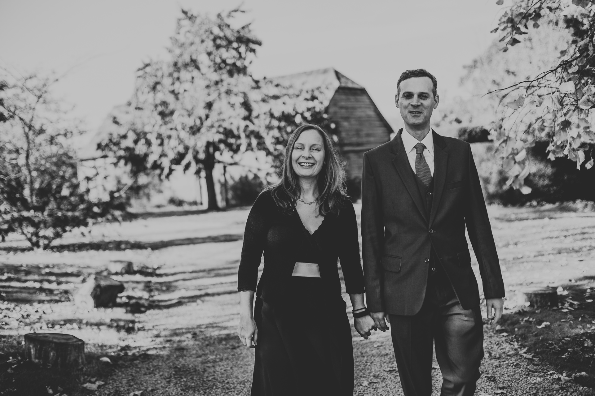 Wedding guests walking hand in hand. Photograph in black and white.