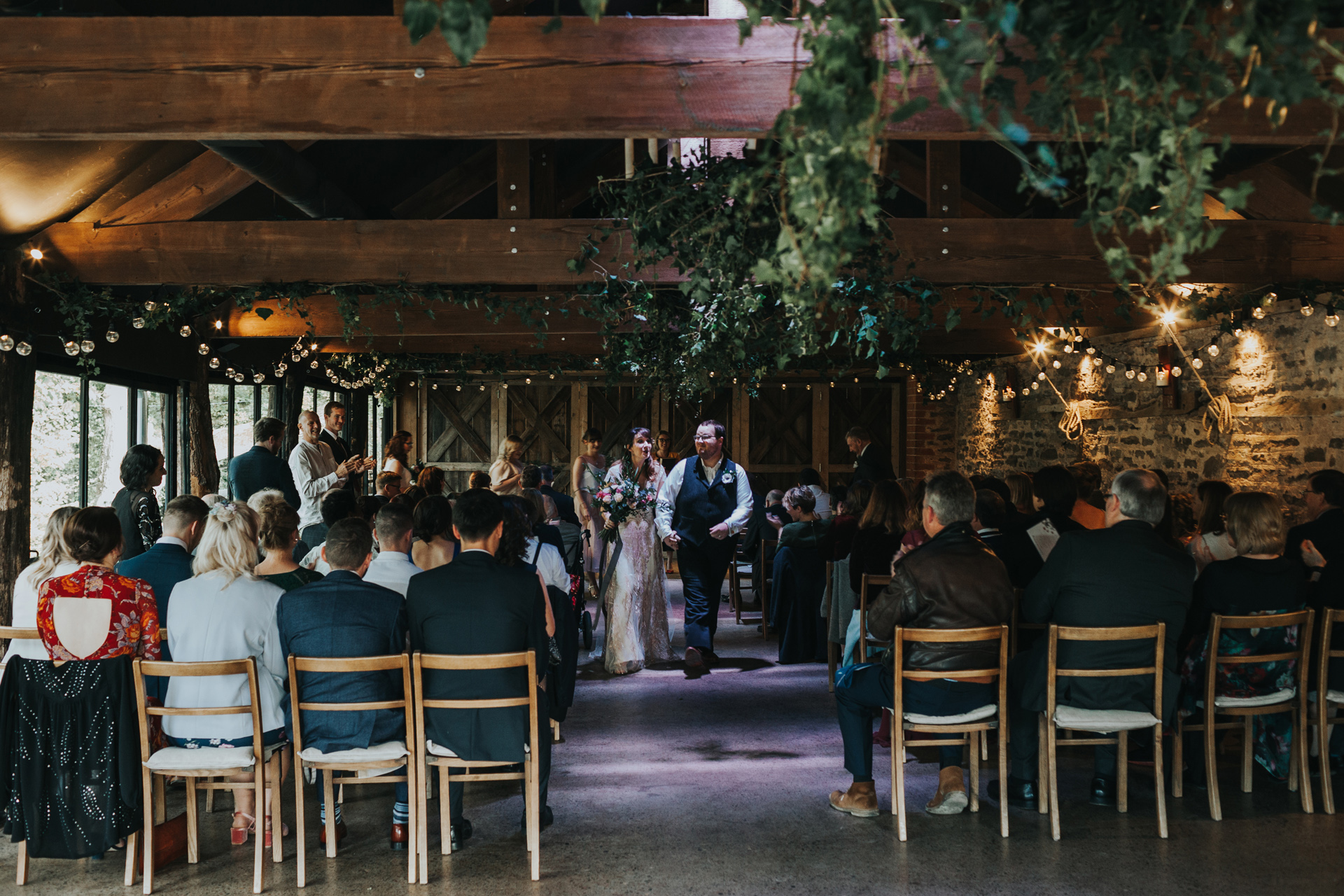 Bride and groom walk down the aisle together at Deswall Court.