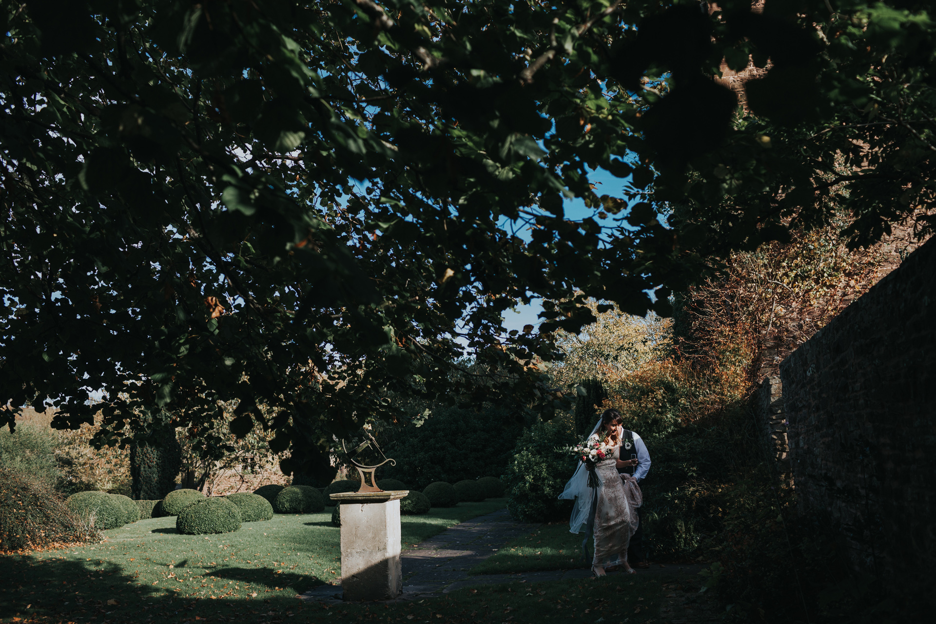 The couple walk through the grounds at Dewsall Court. 