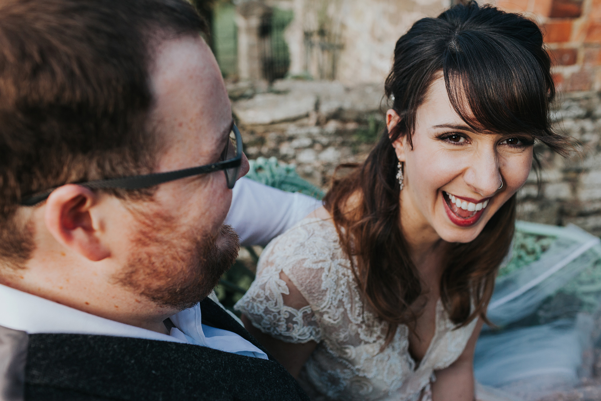 Bride laughing with groom.