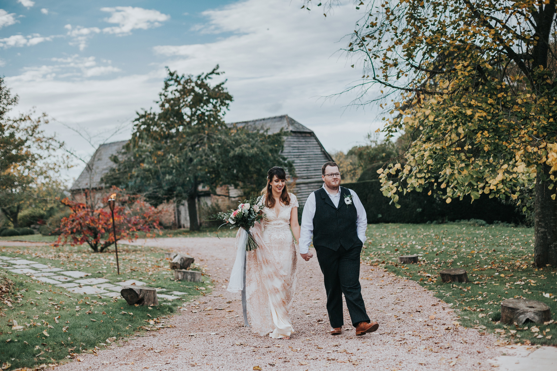 Bride and groom walking to wedding breakfast. 