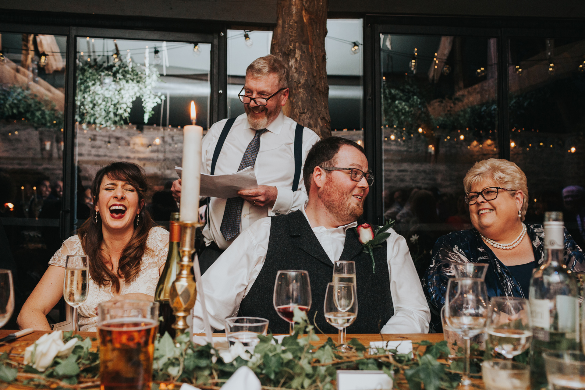 Everyone laughing at Groom's Dad's Speech. 