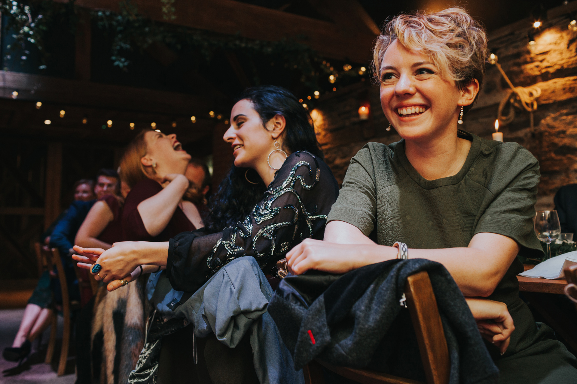 Guests laughing at Groom's speech. 